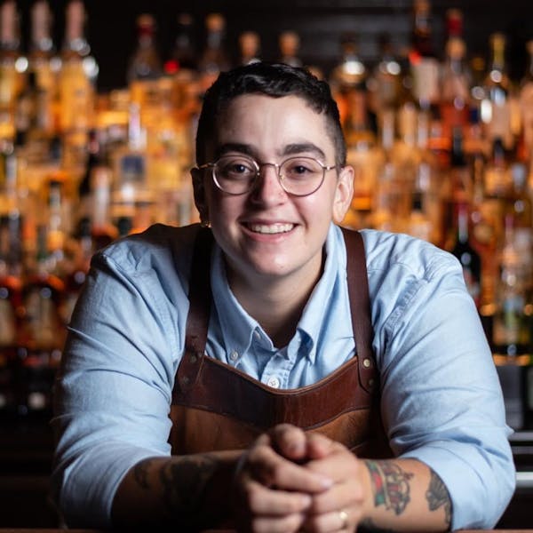 a person sitting at a table smiling for the camera
