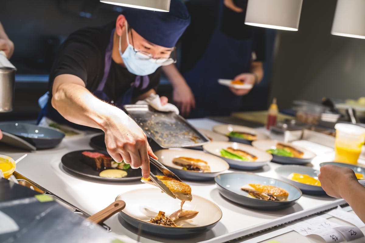 a group of people preparing food in a kitchen