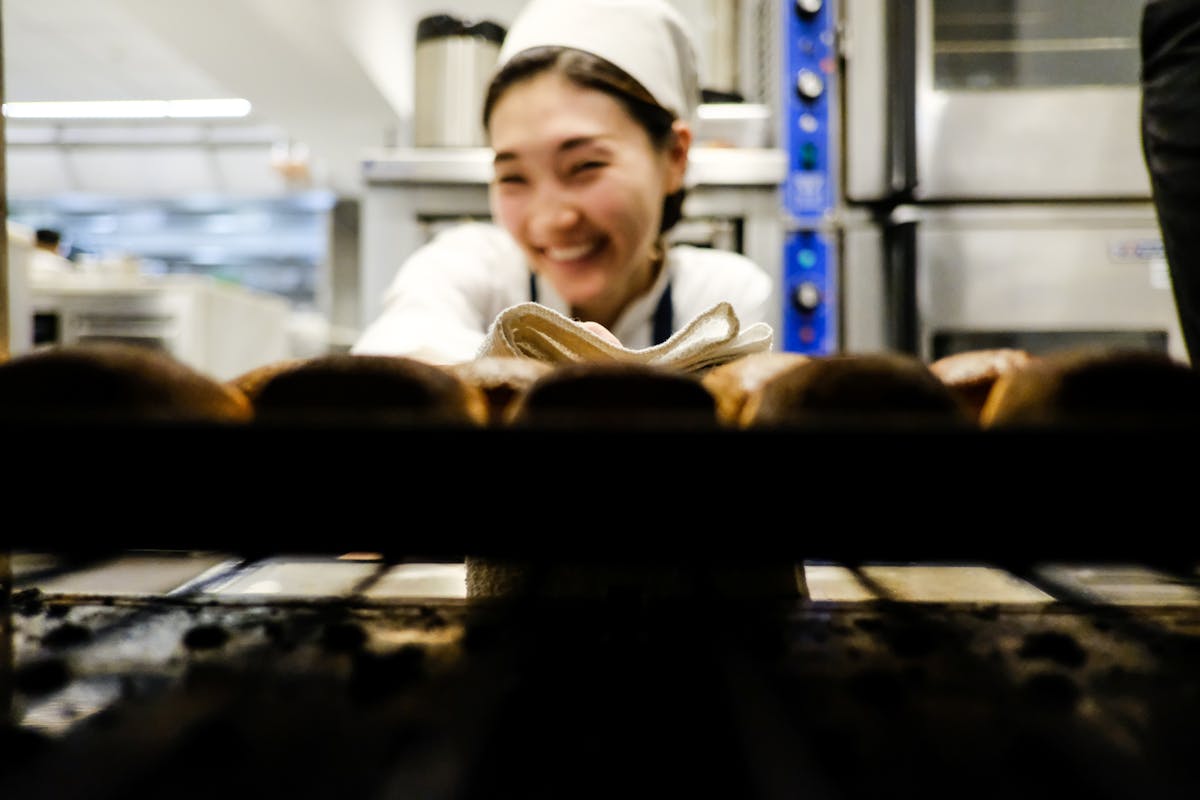 a chef taking out break from the oven