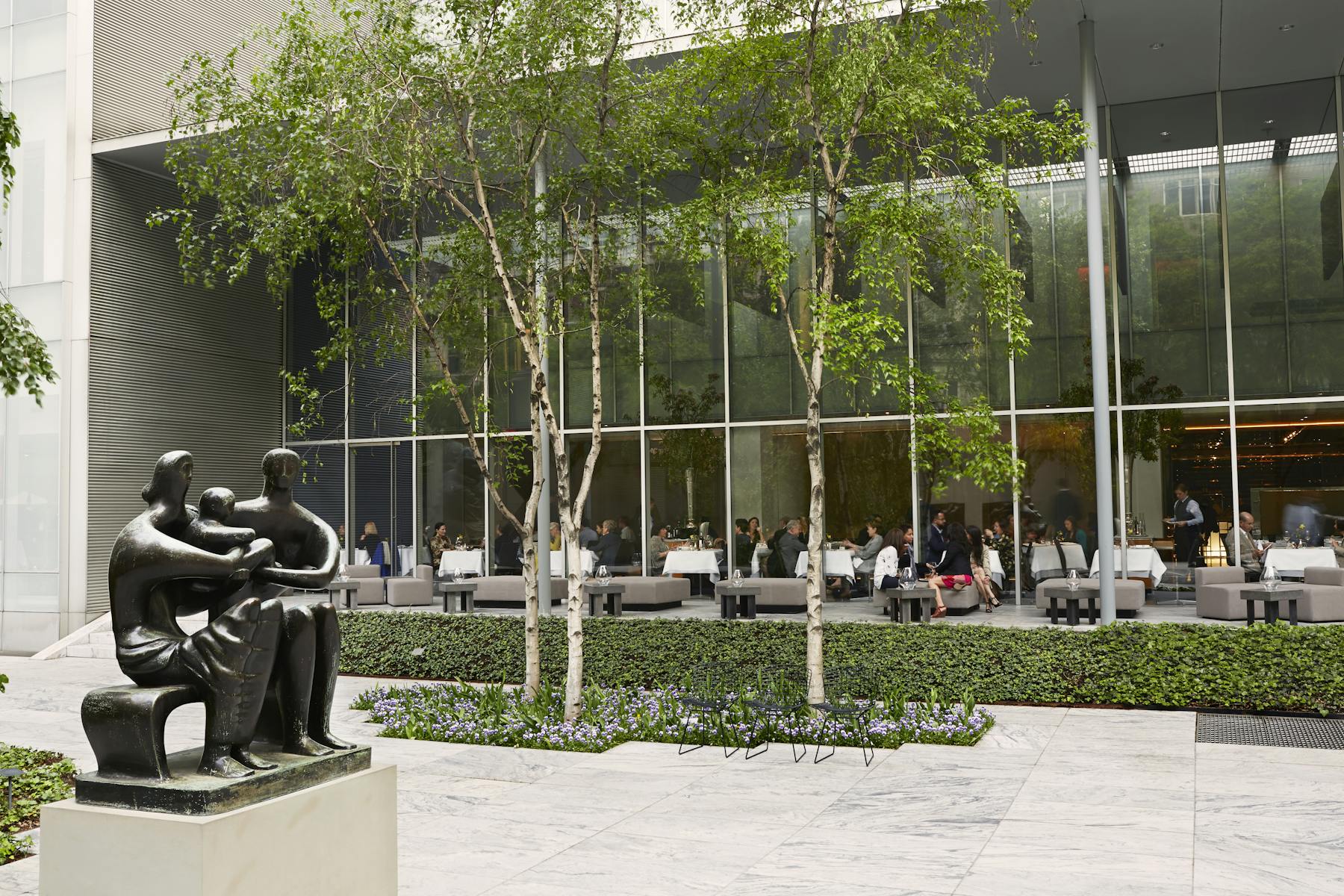 a statue of a family holding a baby outside the restaurant