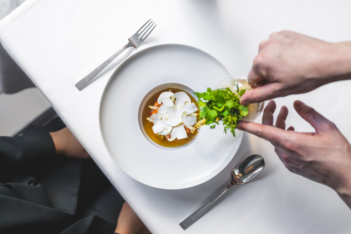 a person cutting food on a plate