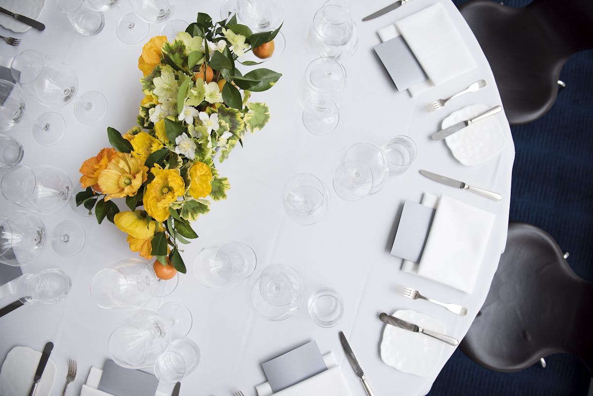 yellow flowers set as a vase on an event table