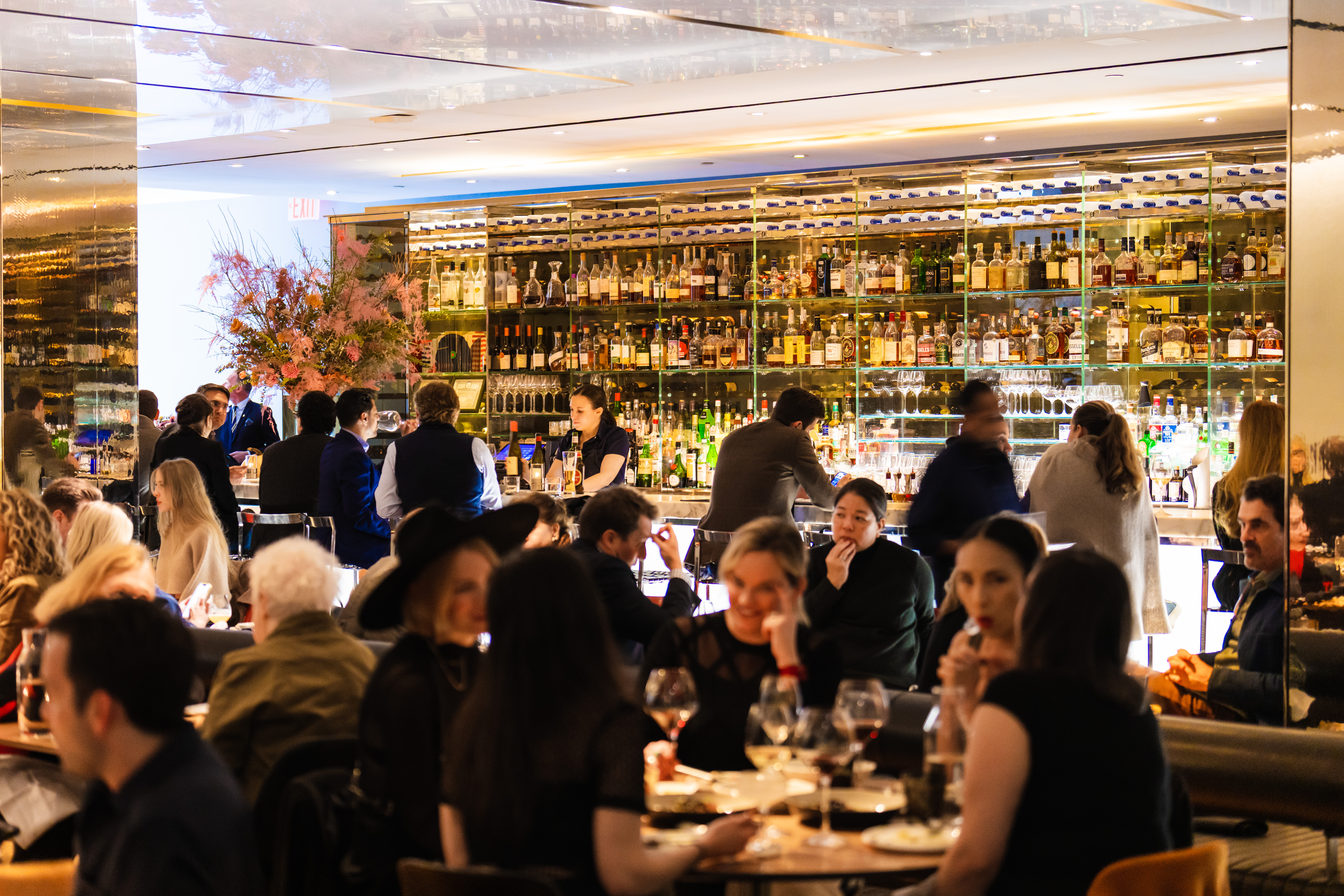 a group of people sitting at tables in a restaurant