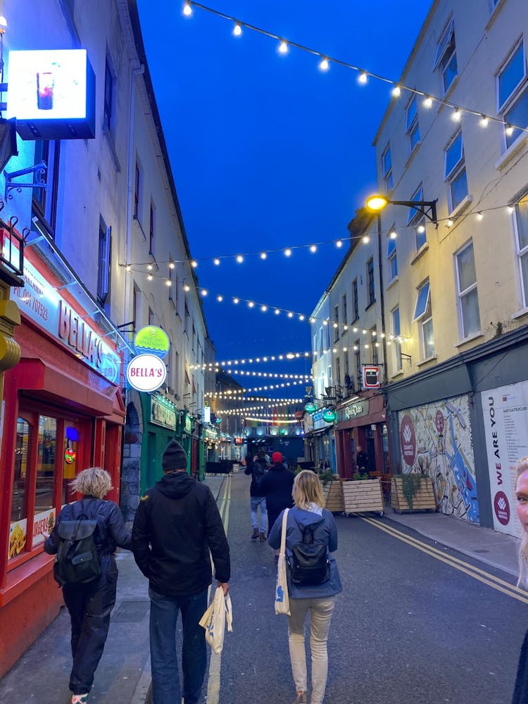 a group of people walking on a city street