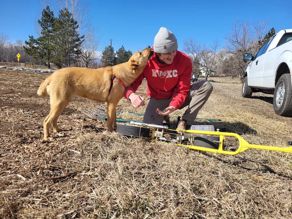 a man standing next to a dog