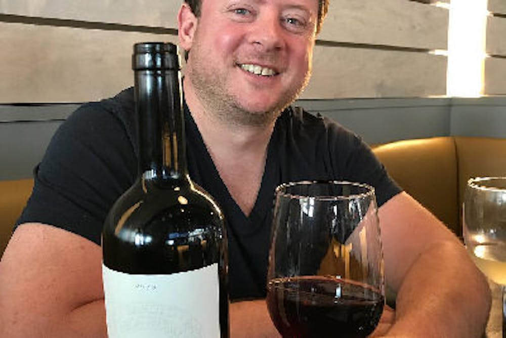 a man holding a glass of wine