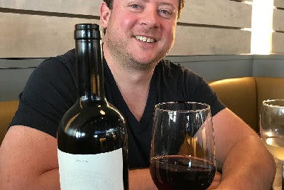 a man holding a glass of wine