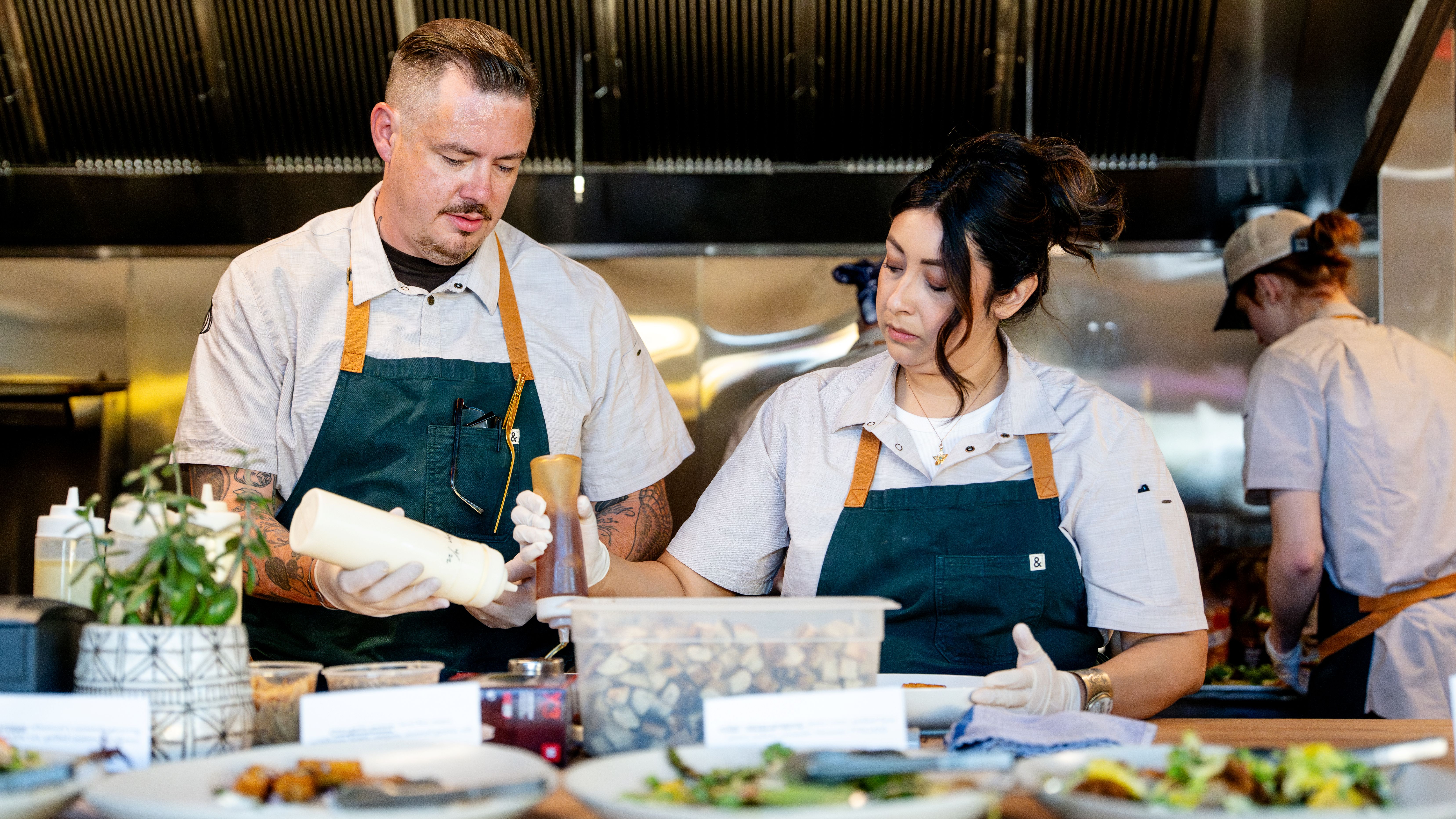a man and woman wearing aprons