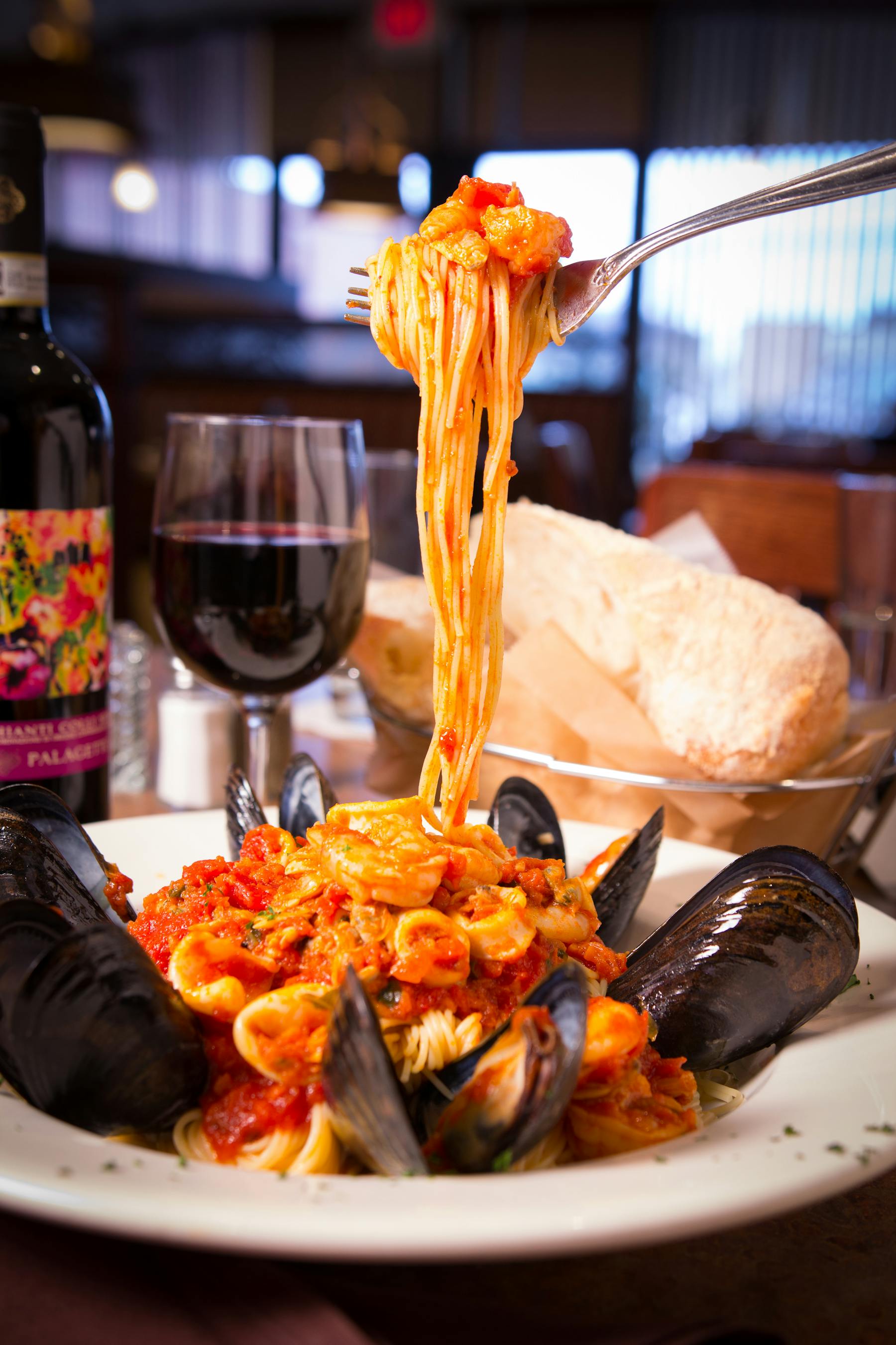 a plate of food and a glass of wine