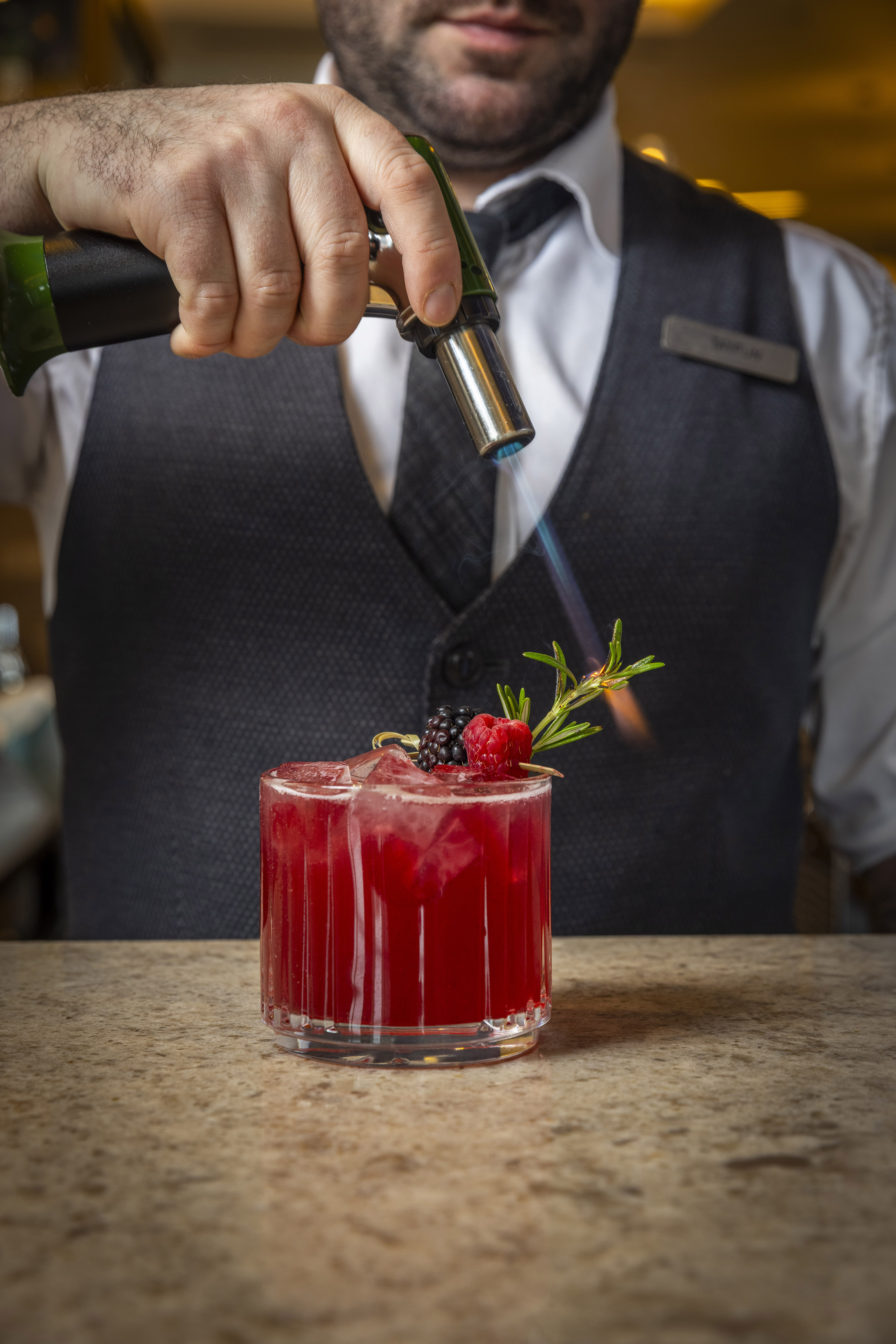 a man standing in front of a cake