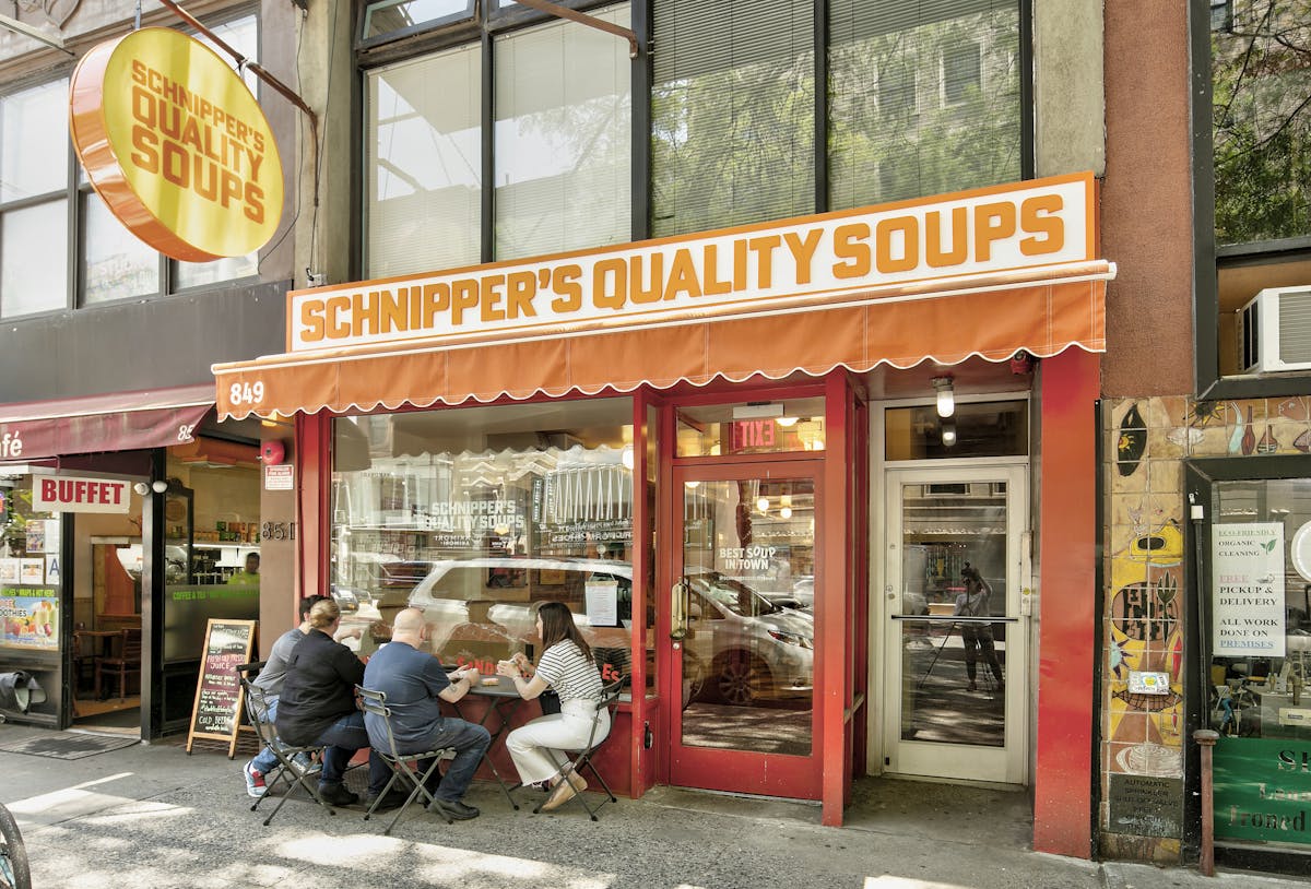a group of people sitting in front of a store