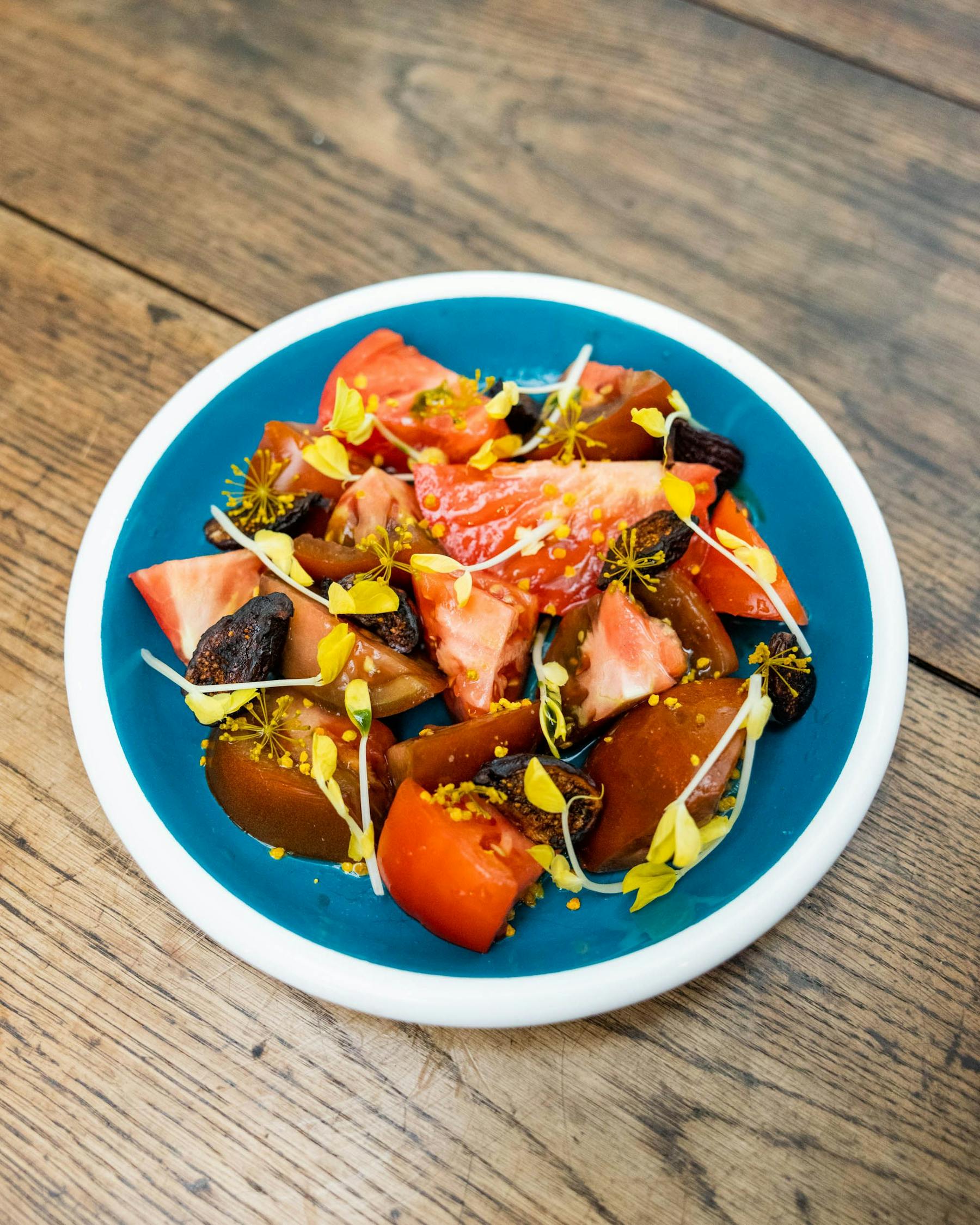a plate of food sitting on top of a wooden table