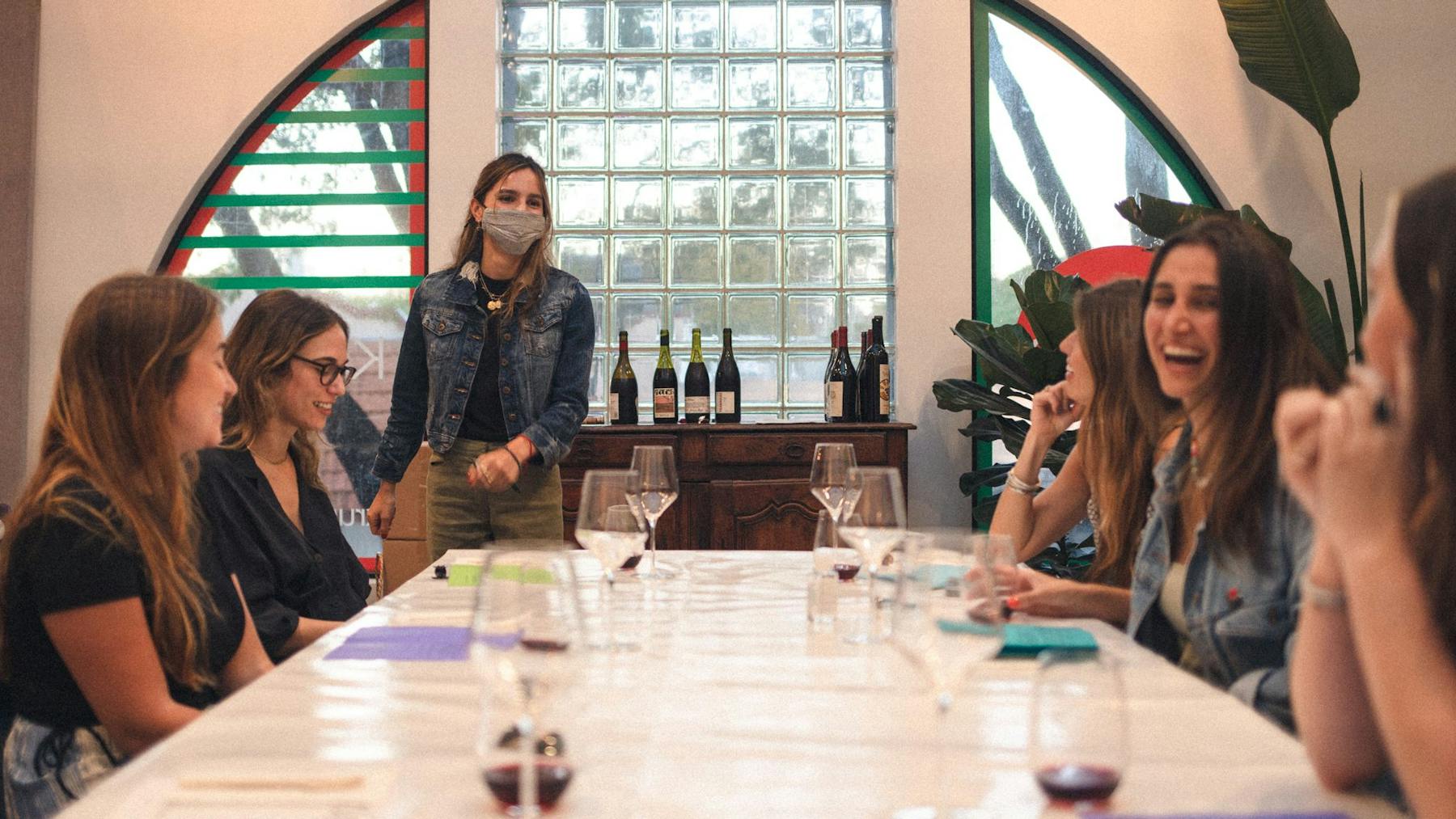 a group of people sitting at a table with wine glasses