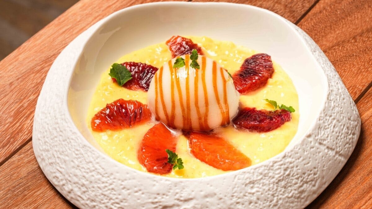 a plate of fruit sitting on top of a wooden table