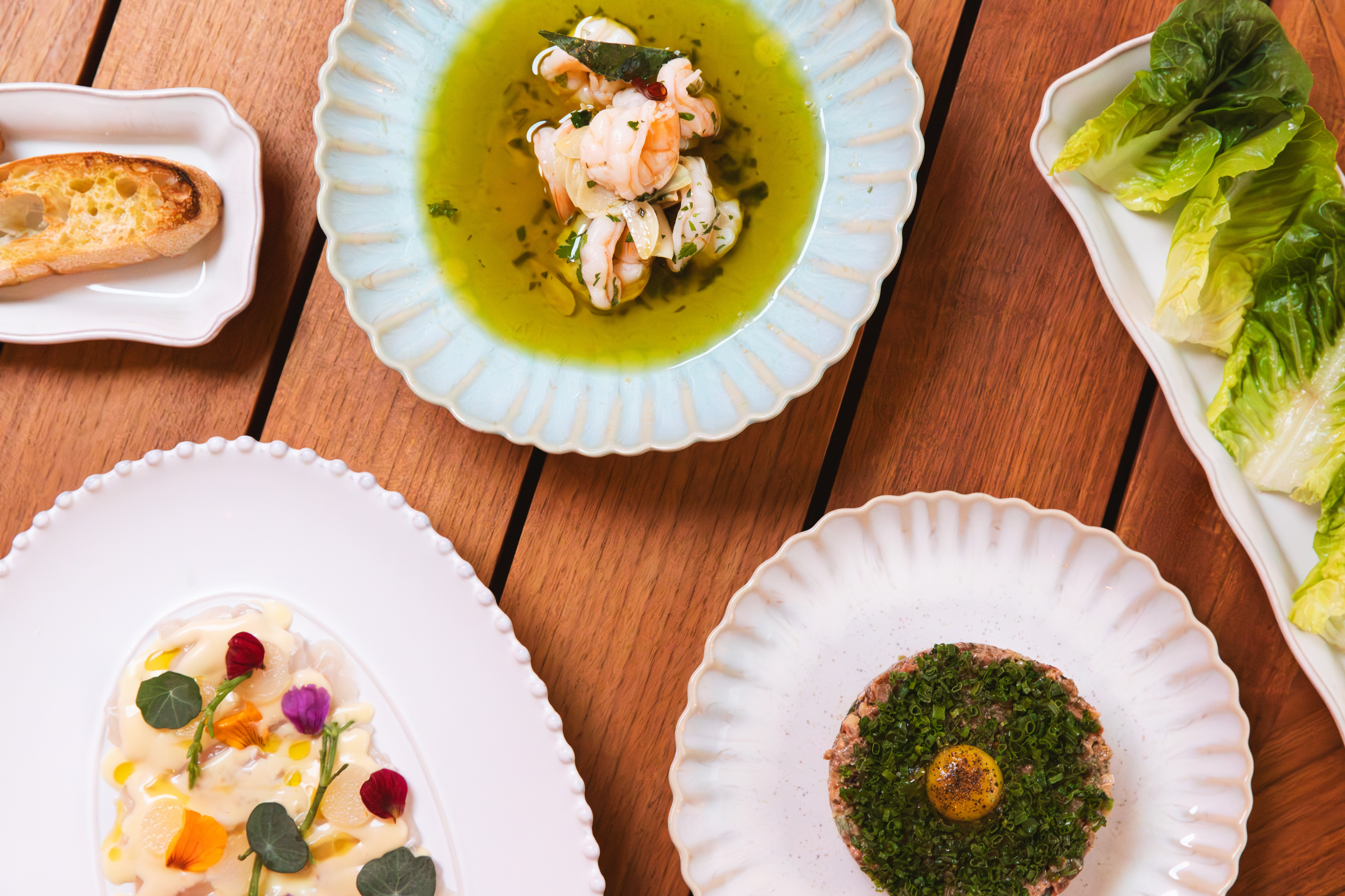 a plate of food sitting on top of a wooden table