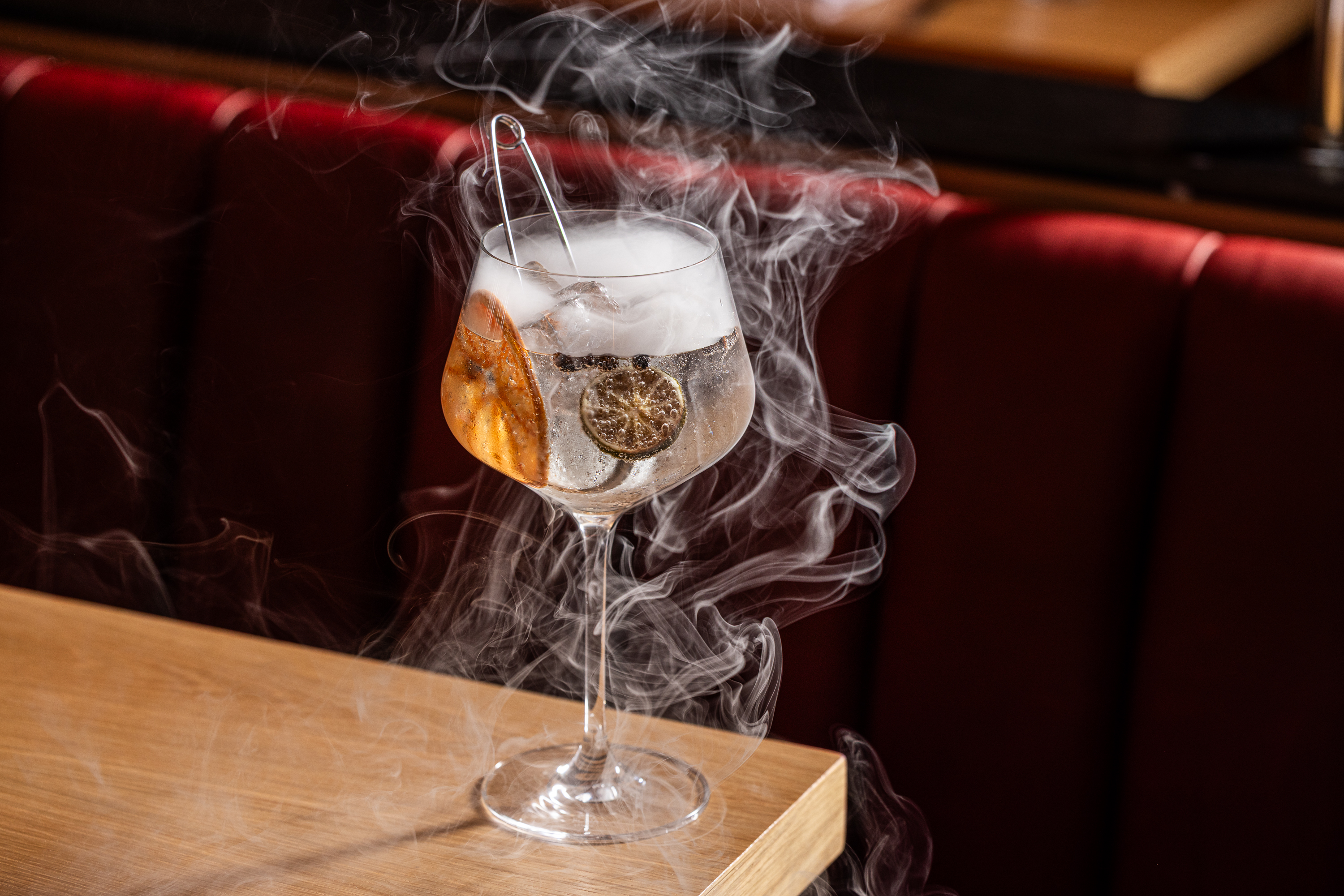 a glass with liquid and smoke