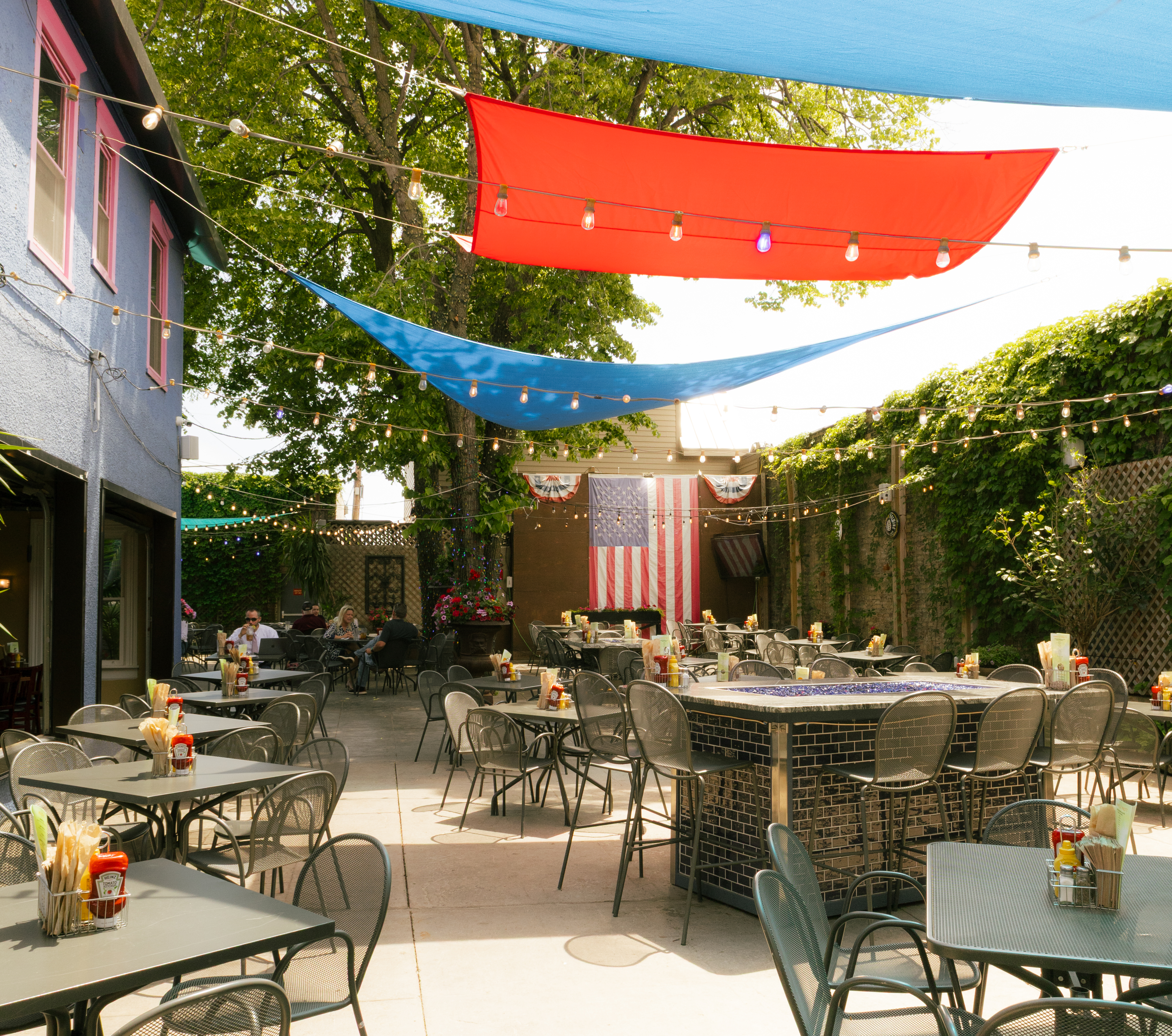 a patio with tables and chairs