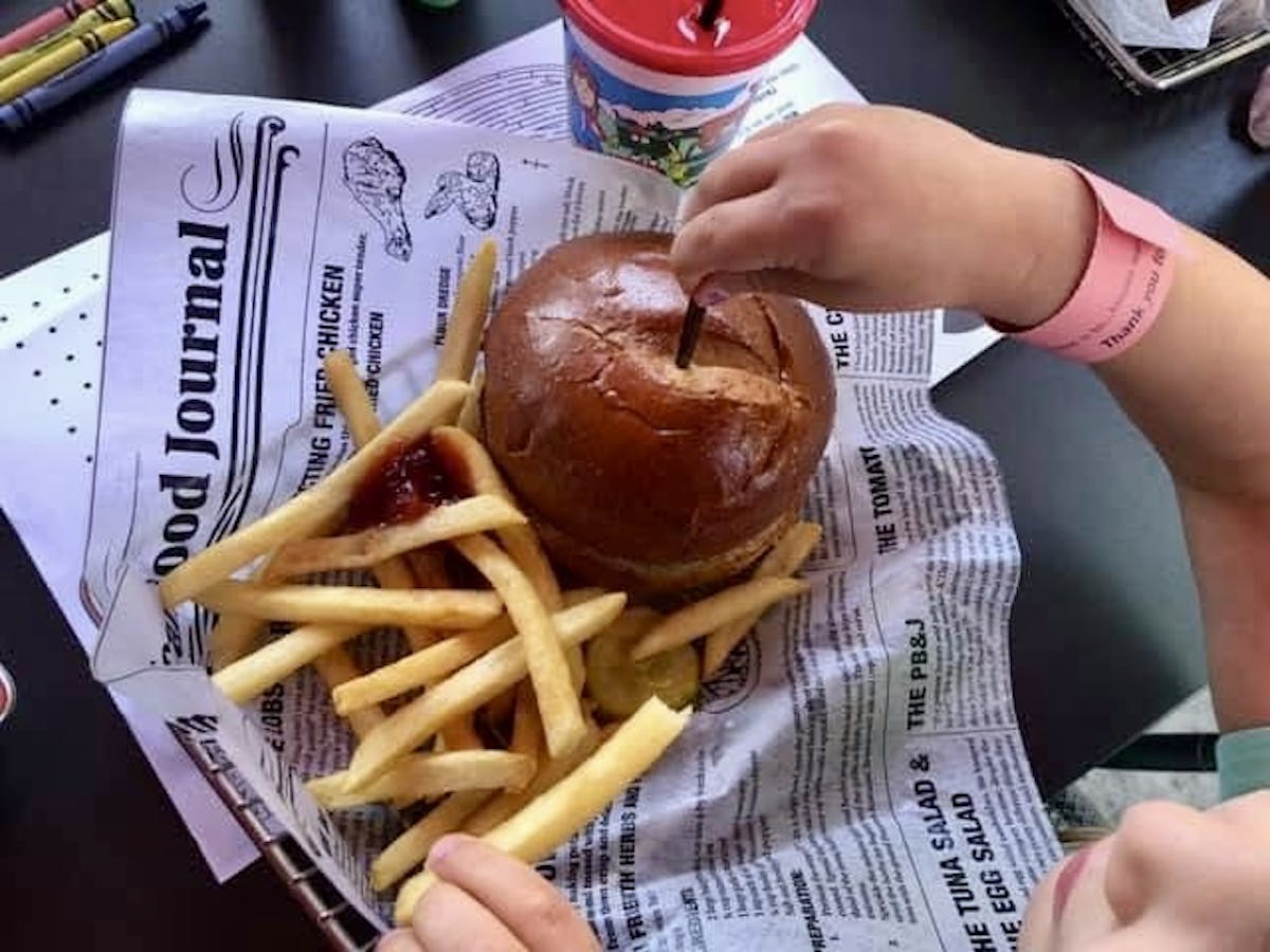 a person holding a hot dog