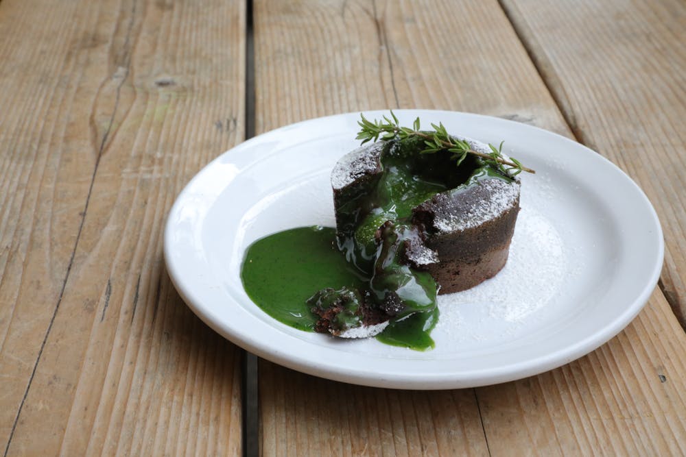 a plate of food sitting on top of a wooden table