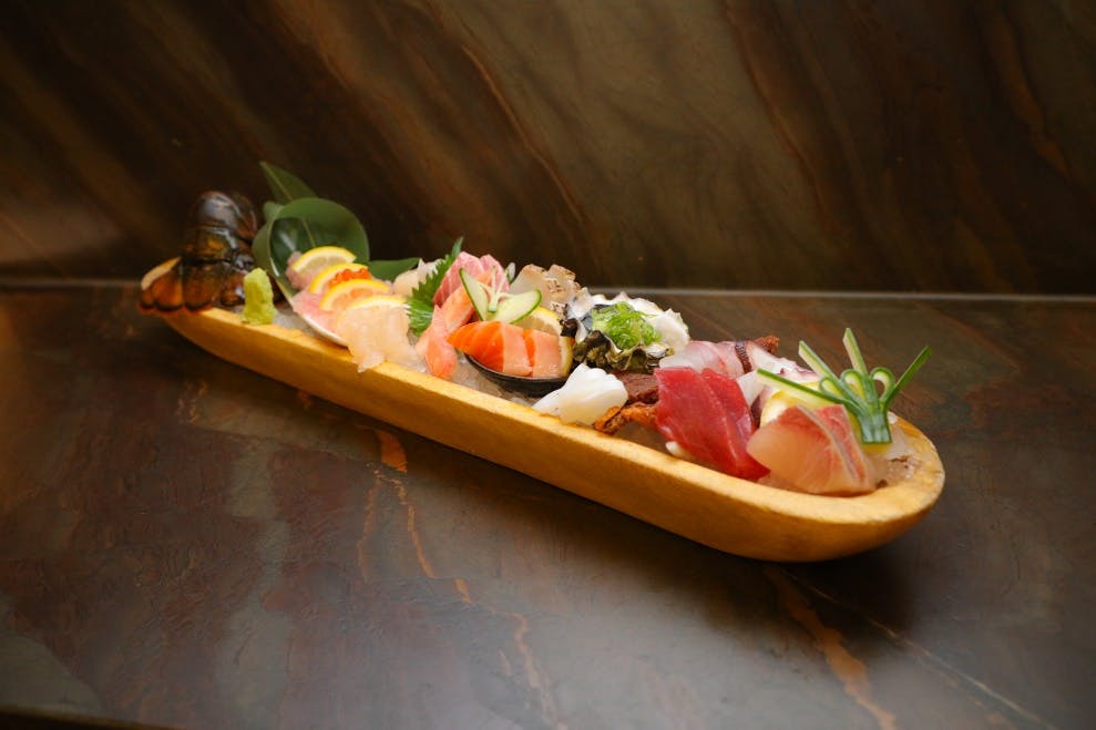 a bowl of fruit sitting on top of a wooden table