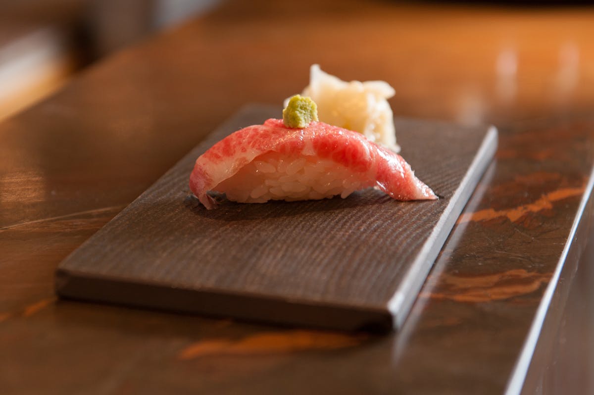 A close up of a singular piece of sushi