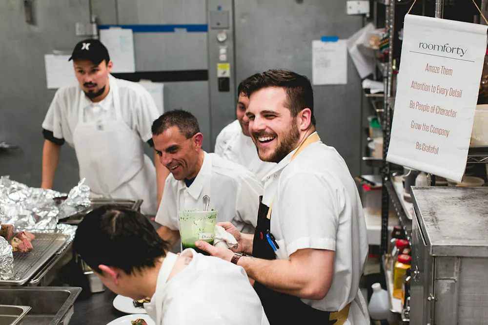 a group of people preparing food in a kitchen