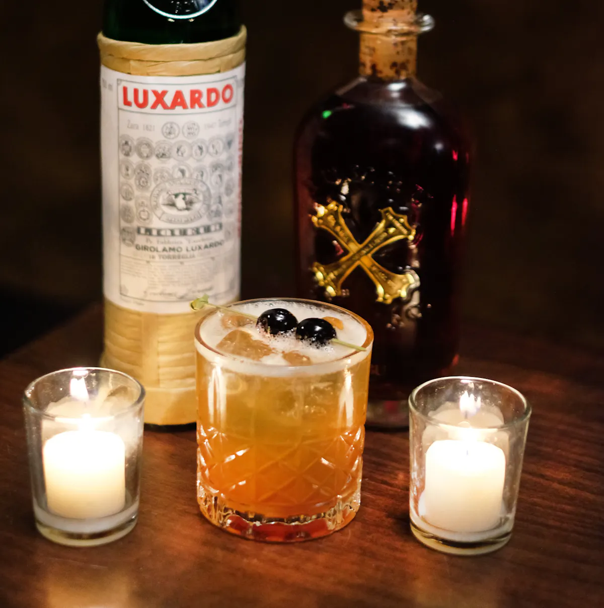 bottles of liquor and a cocktail on a table