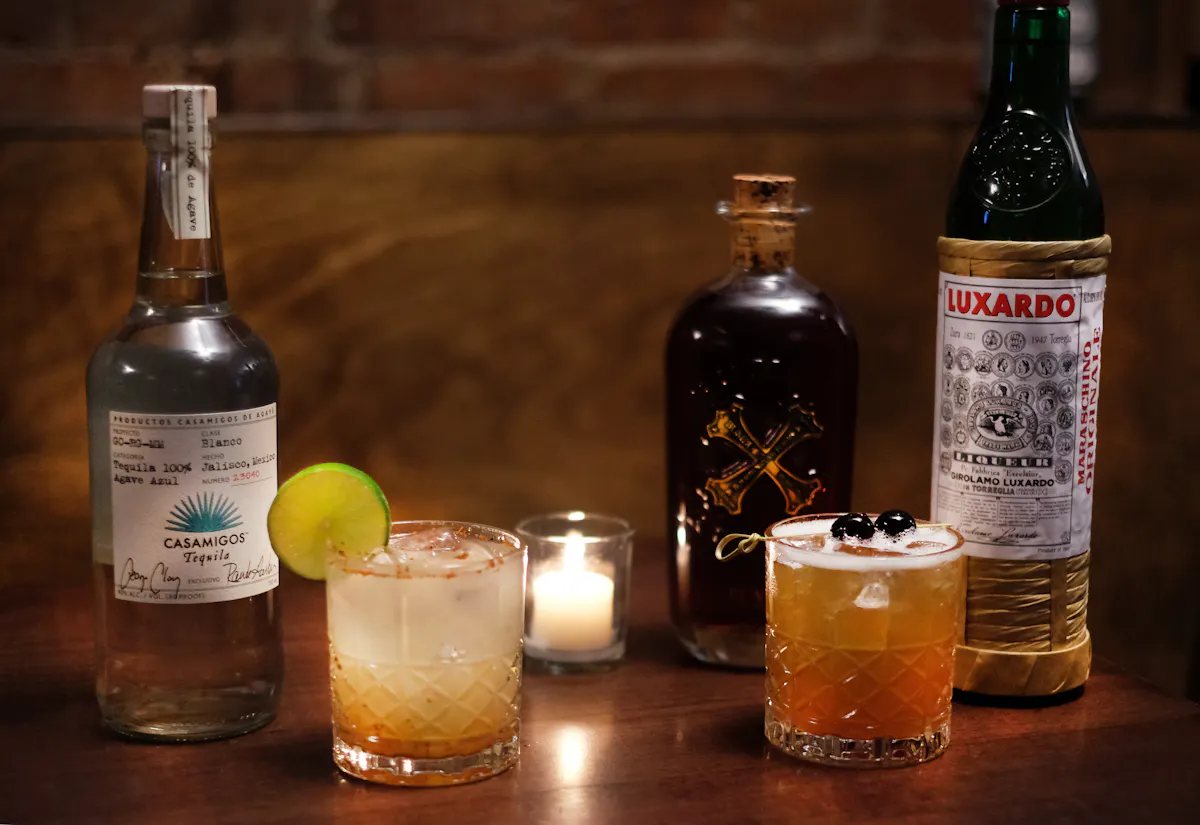 bottles of liquor and cocktailson a table