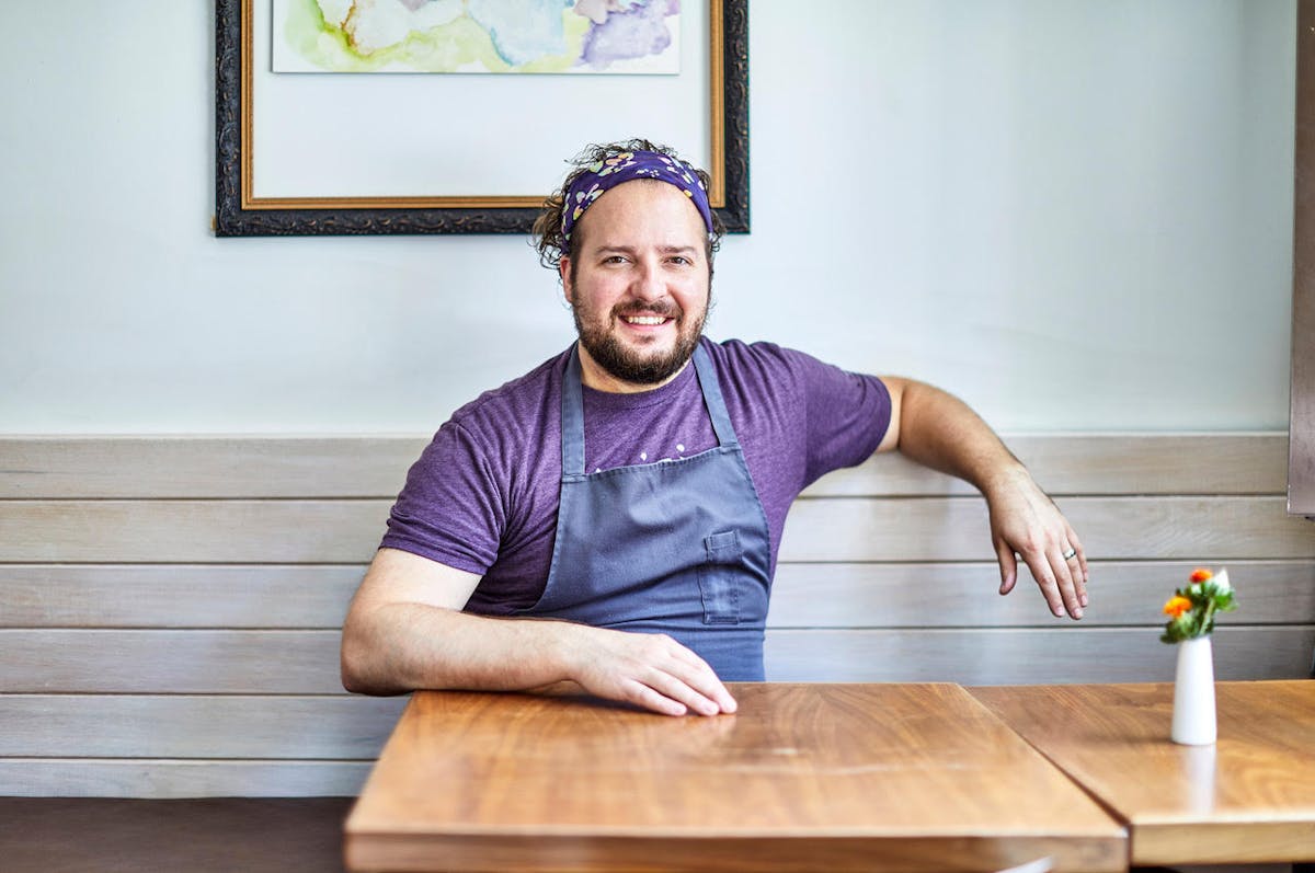 a man sitting on a wooden table