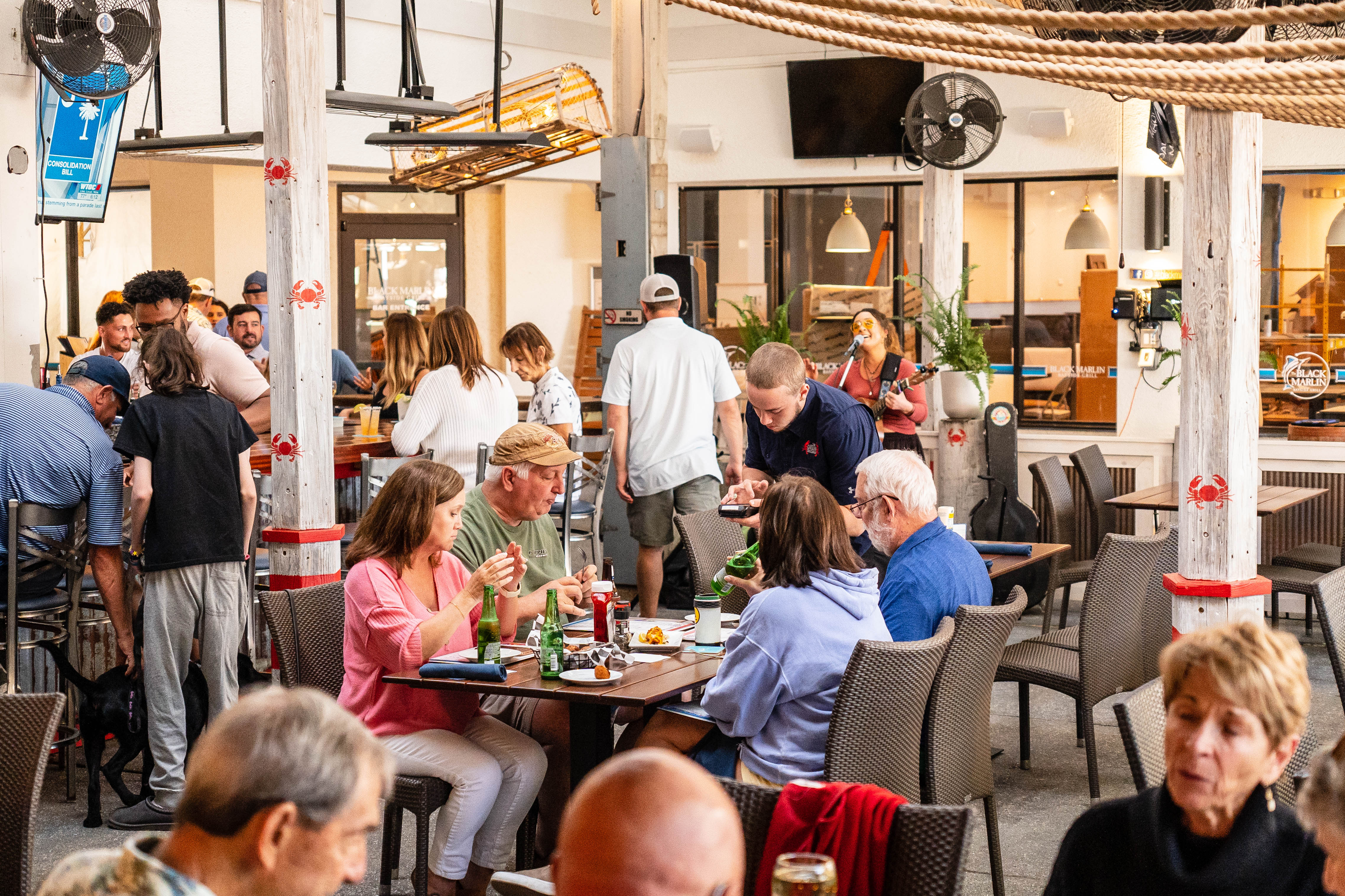 a group of people sitting at a table in a restaurant