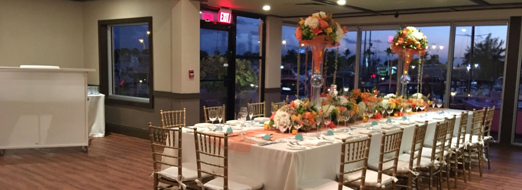 a room filled with furniture and vase of flowers on a table