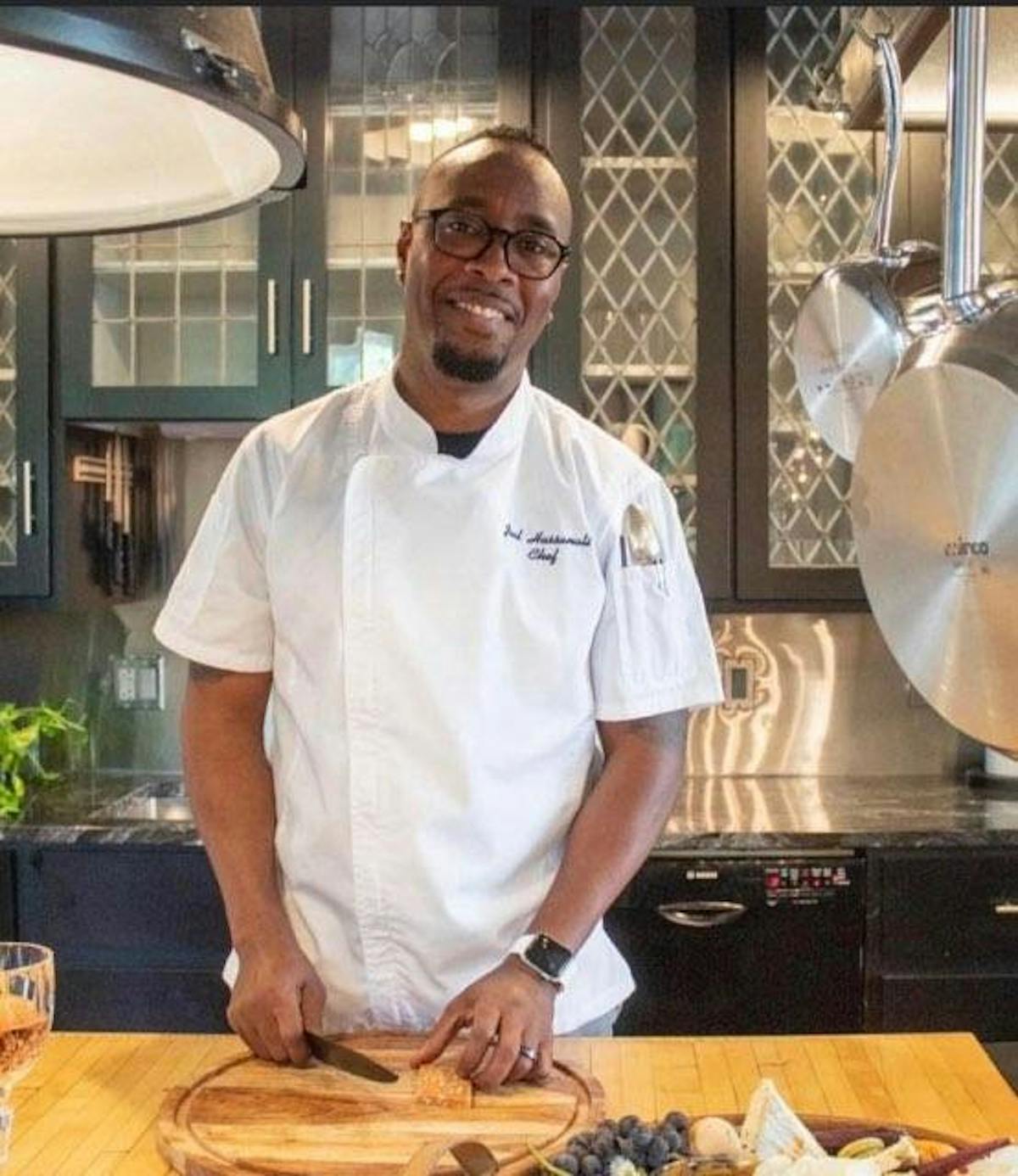 a man standing in a kitchen preparing food