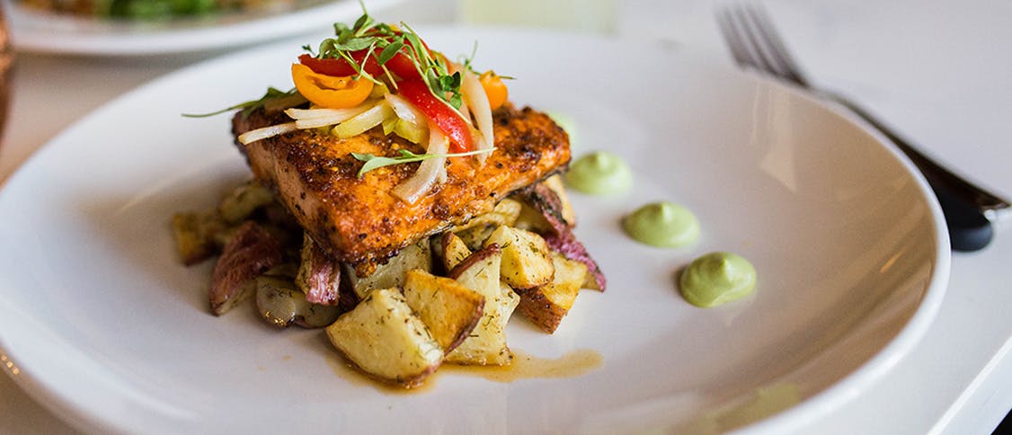 a white plate topped with meat and vegetables