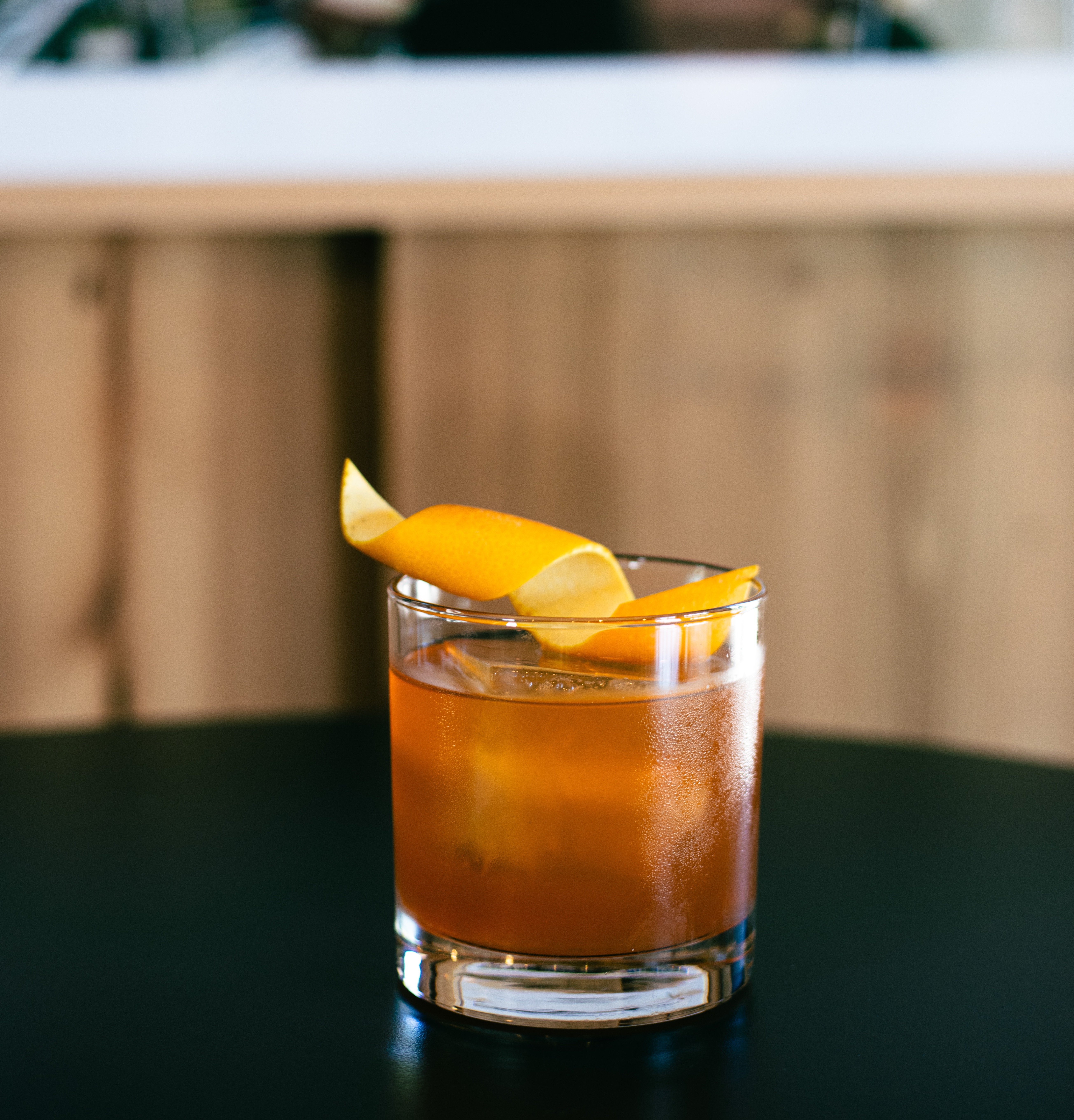 a glass with a drink and a slice of lemon on top