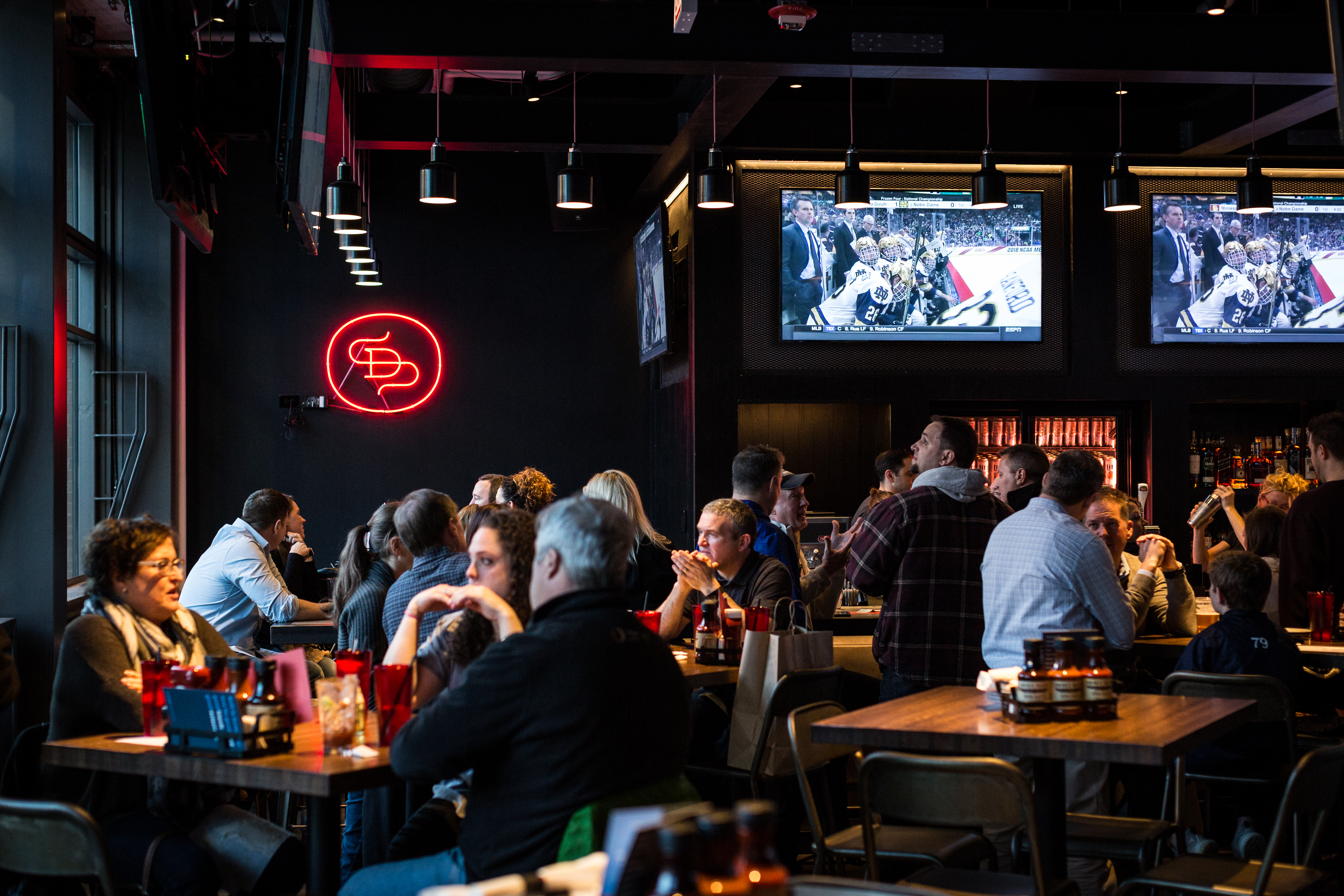 a group of people sitting at a table in a restaurant