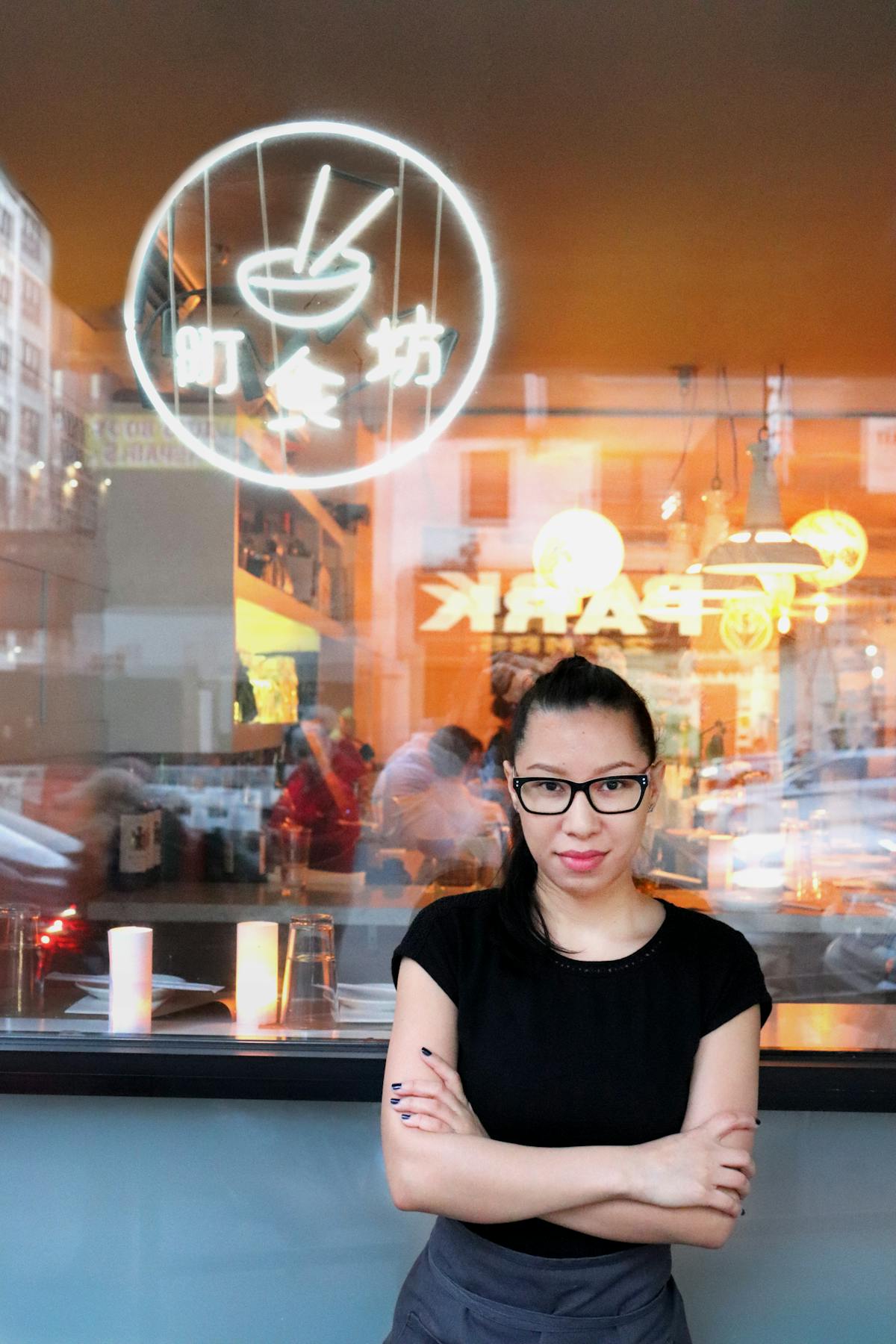 a woman in front of a glass window