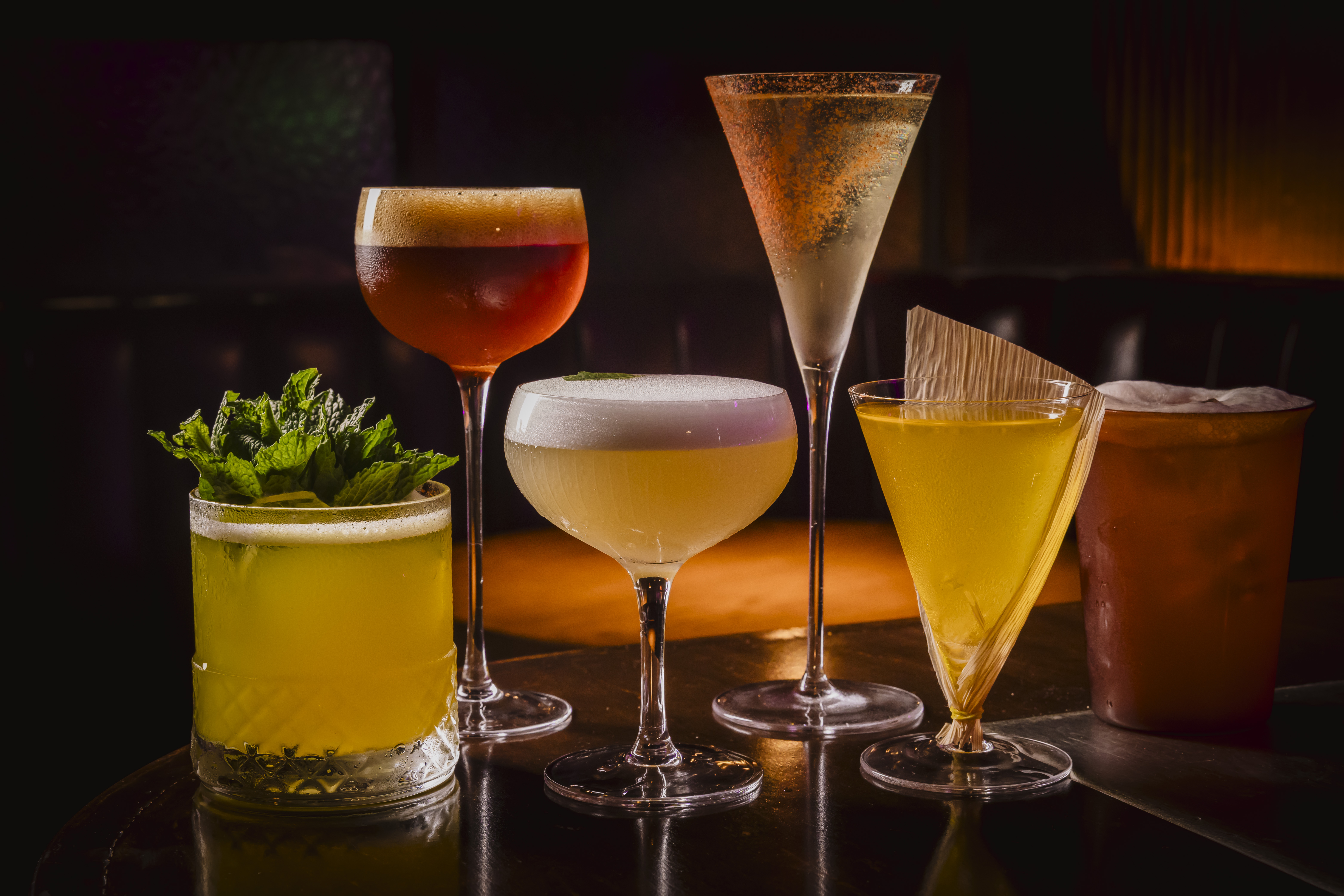 a group of different colored drinks