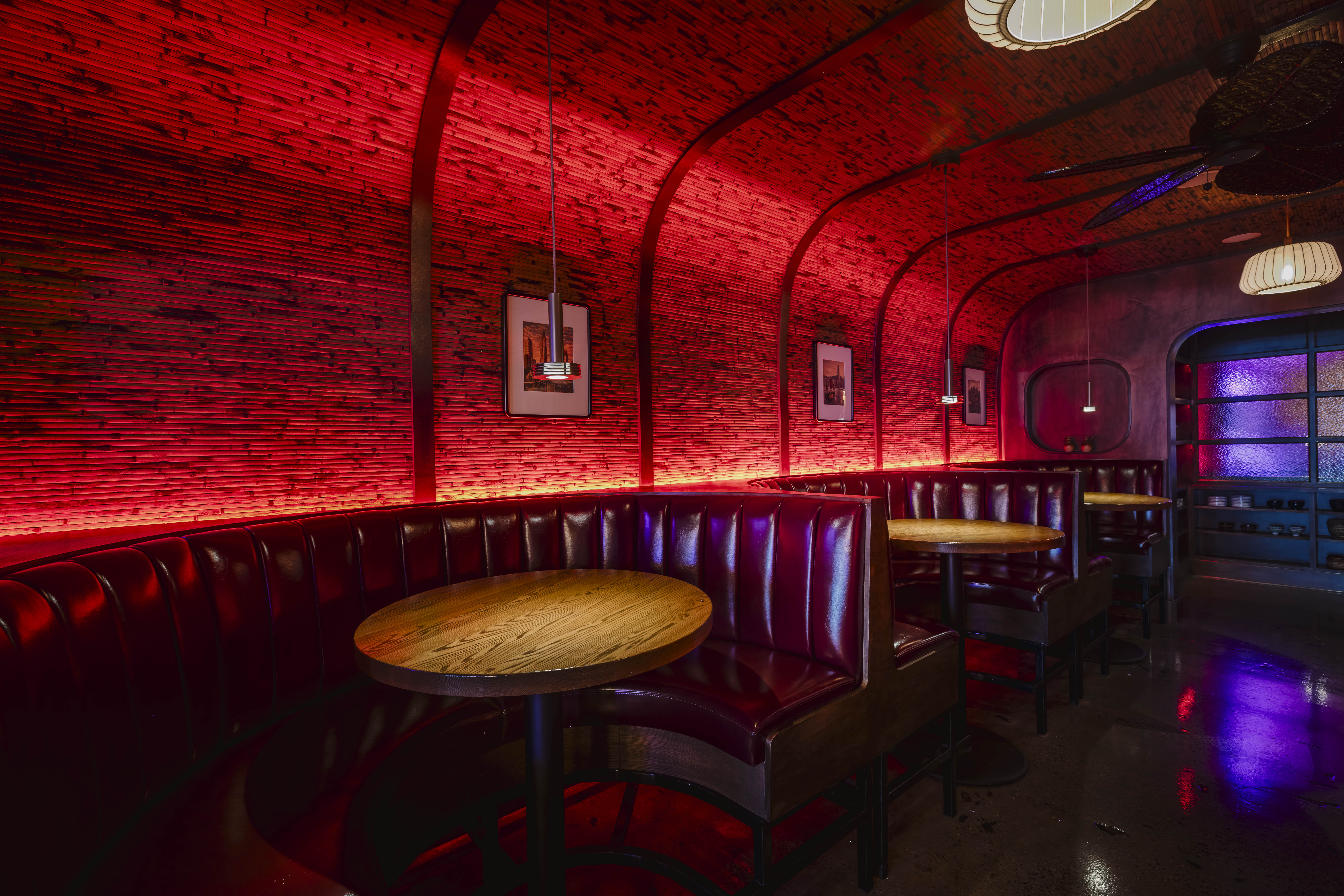 a red room with tables and benches