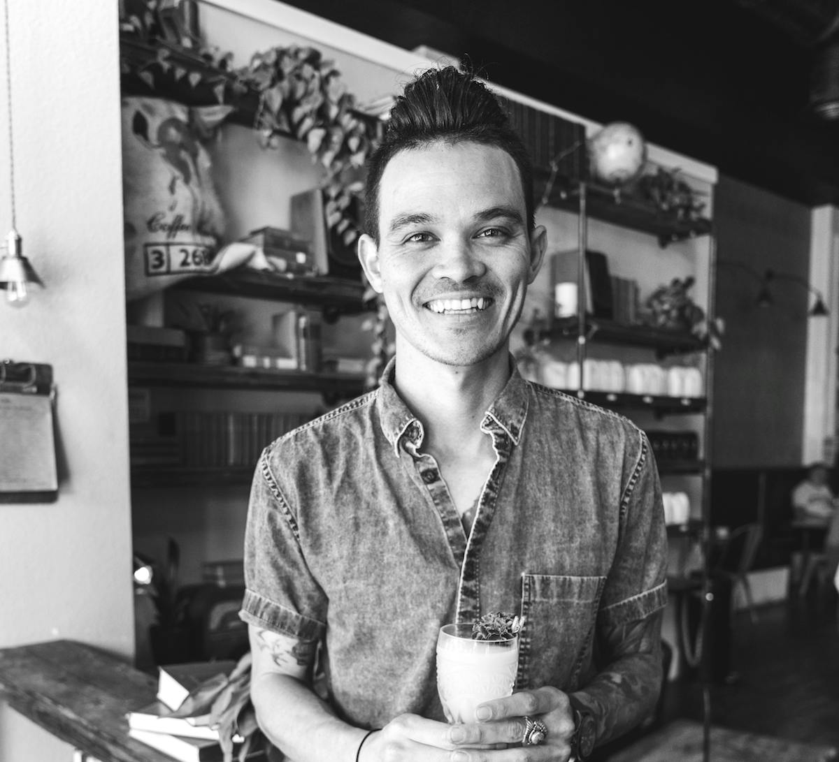 a man standing in front of a restaurant