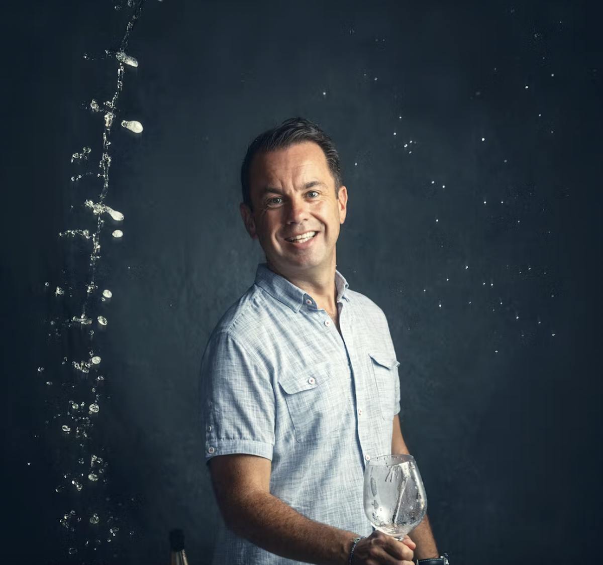 a man standing on a stage posing for the camera