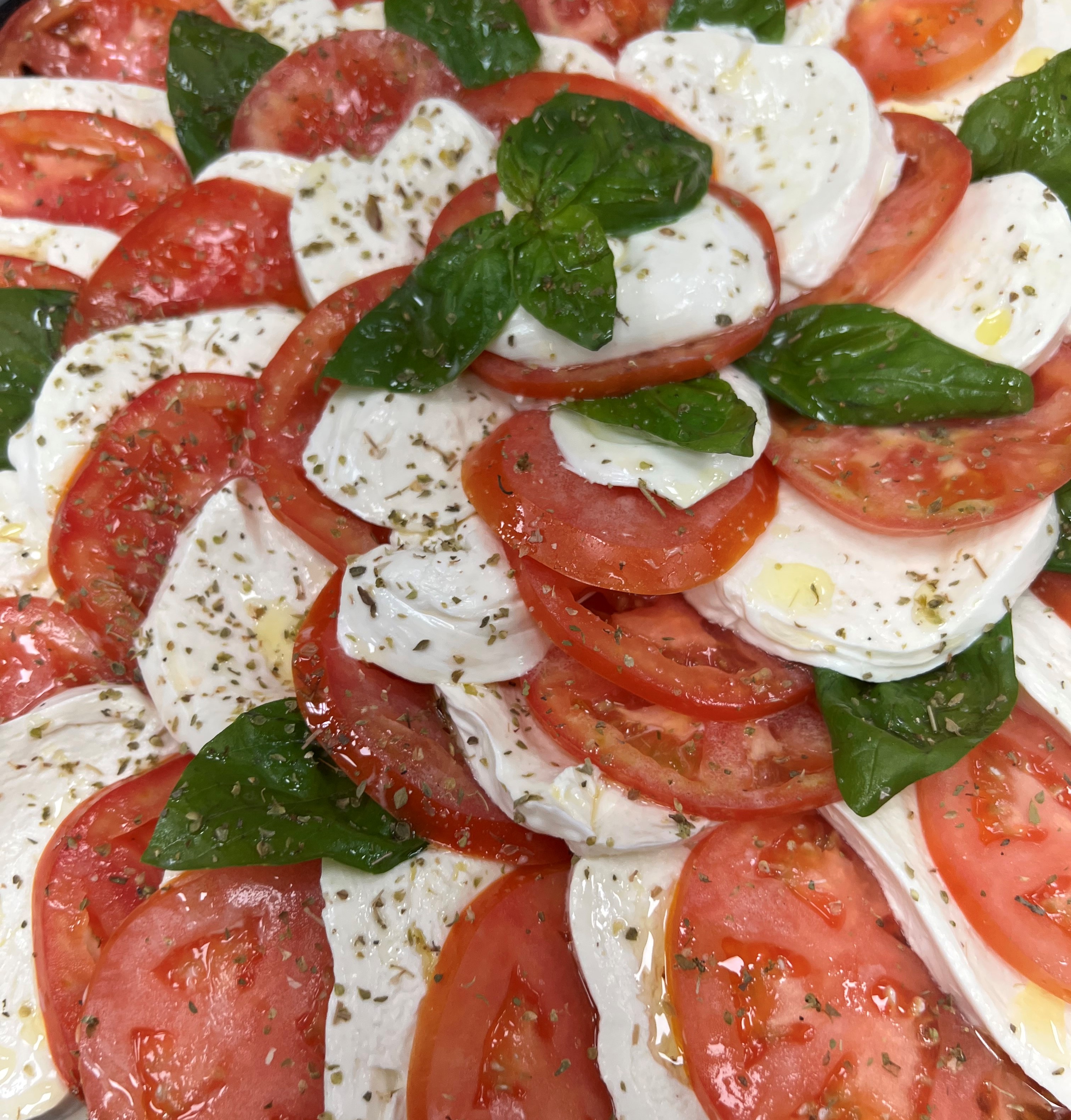 a close up of a tomato pizza on a plate