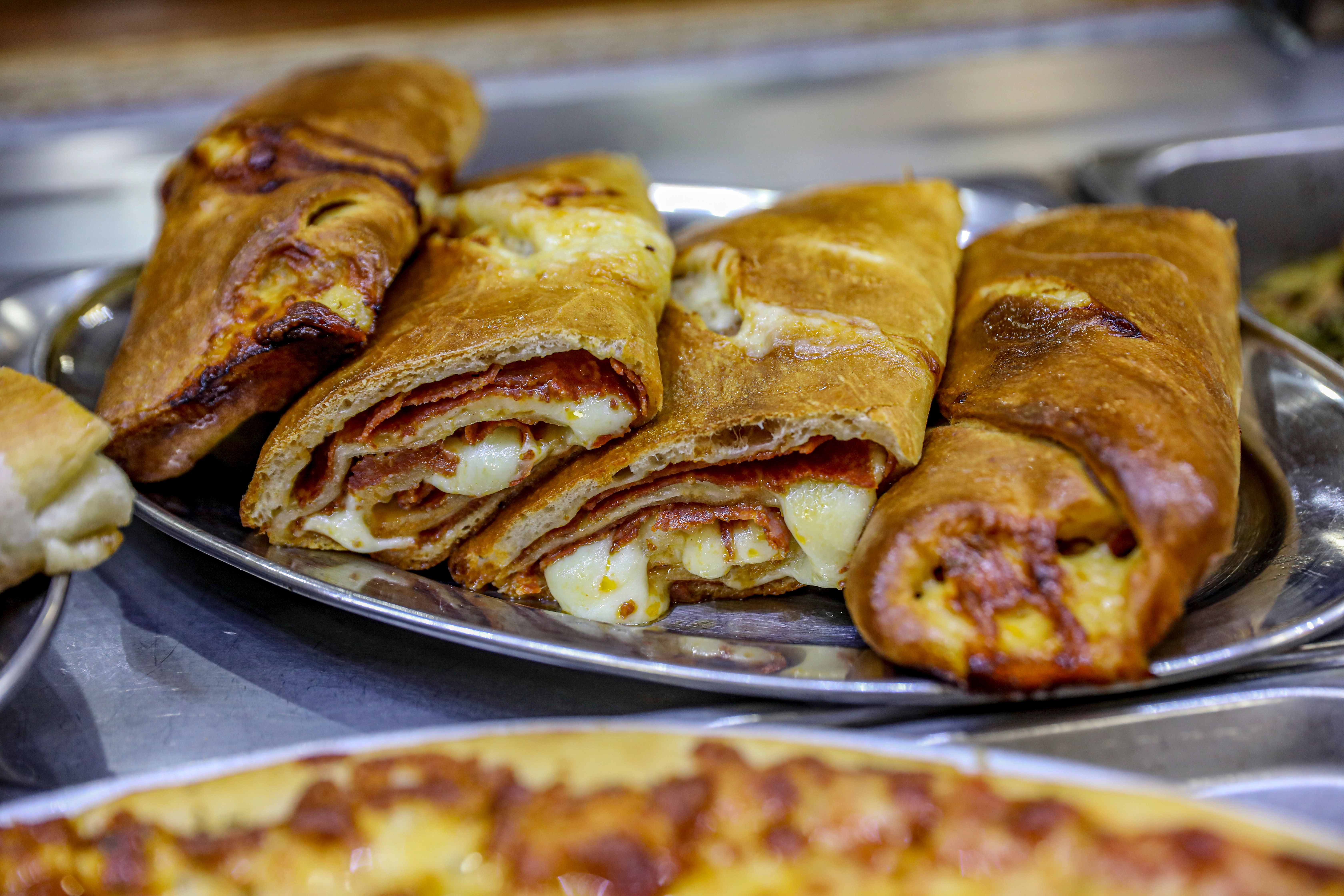 a plate of food with a slice of pizza