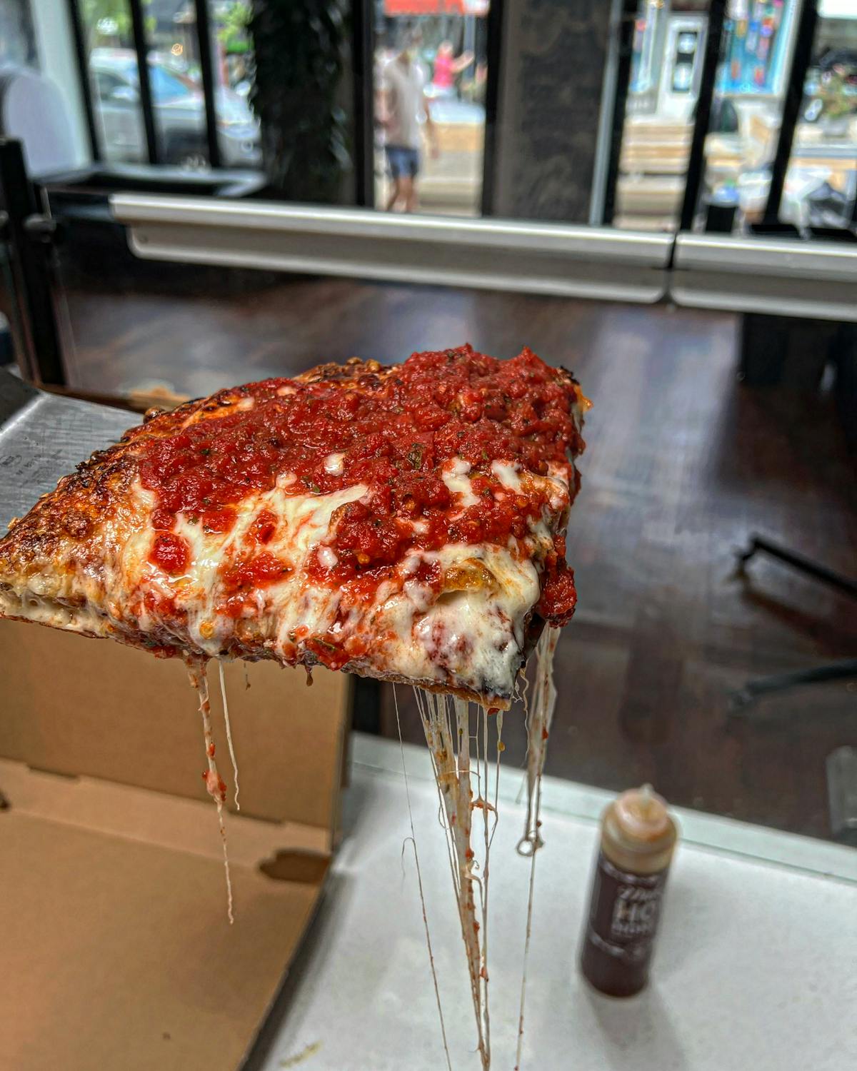 a slice of pizza sitting on top of a table