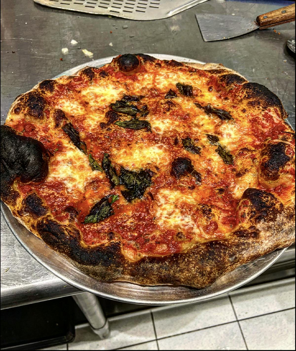 a pizza sitting on top of a metal pan