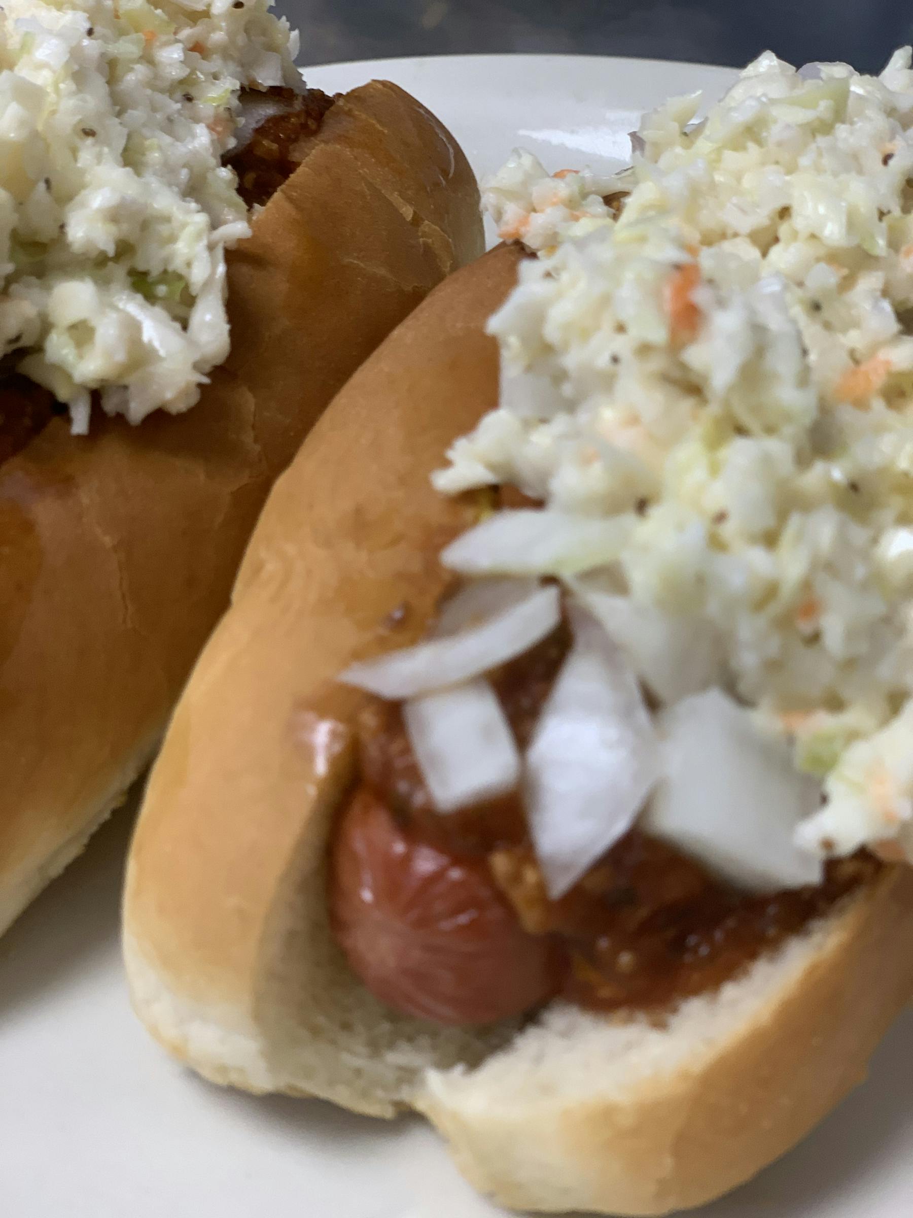 a close up of a plate of hot dogs and rice