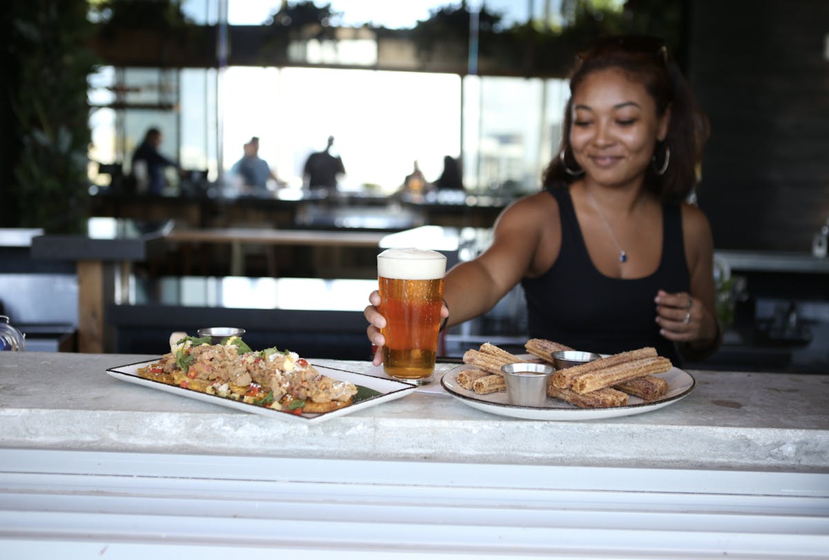 a woman sitting at a table with a plate of food