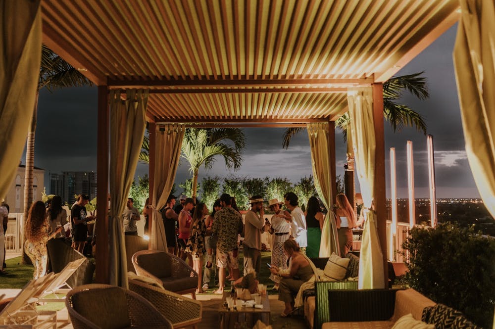 a group of people sitting at a table in front of a window