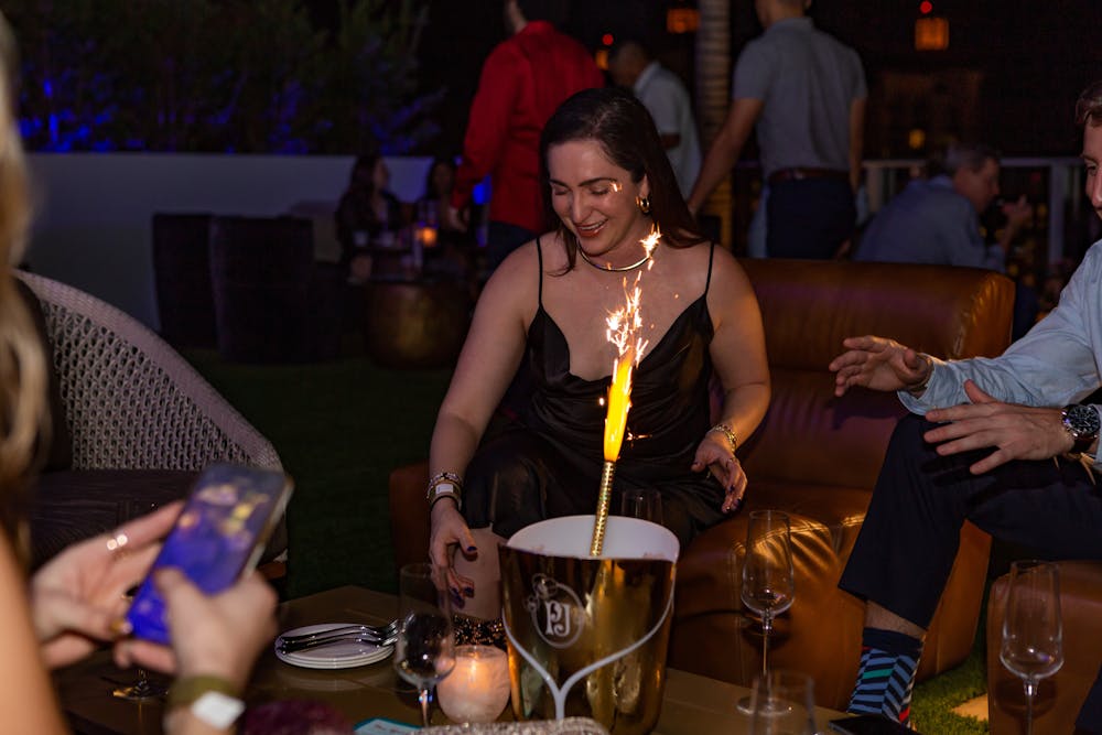 a person sitting at a table with a cake