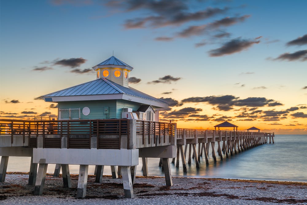 a wooden pier next to a body of water