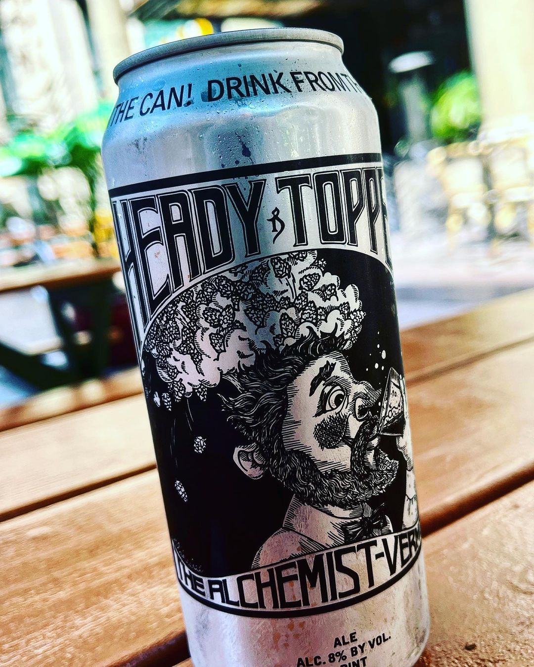 a can and a glass of beer on a table